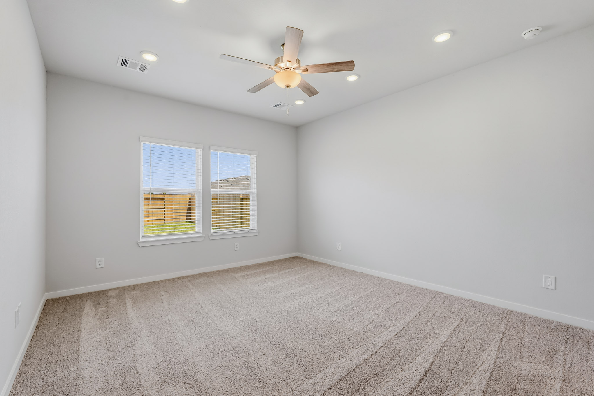 A room with a ceiling fan and a ceiling fan.