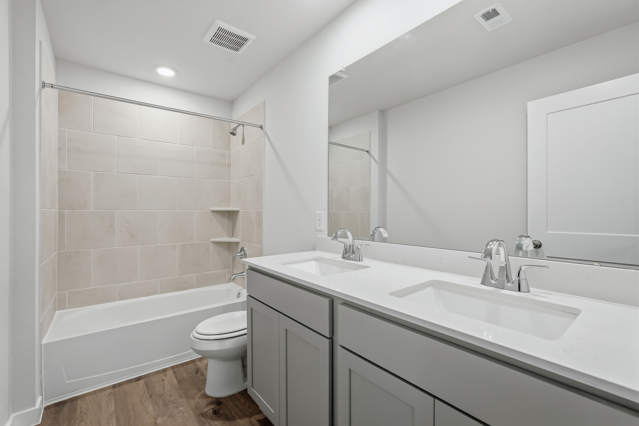 A bathroom with a tub sink and toilet.