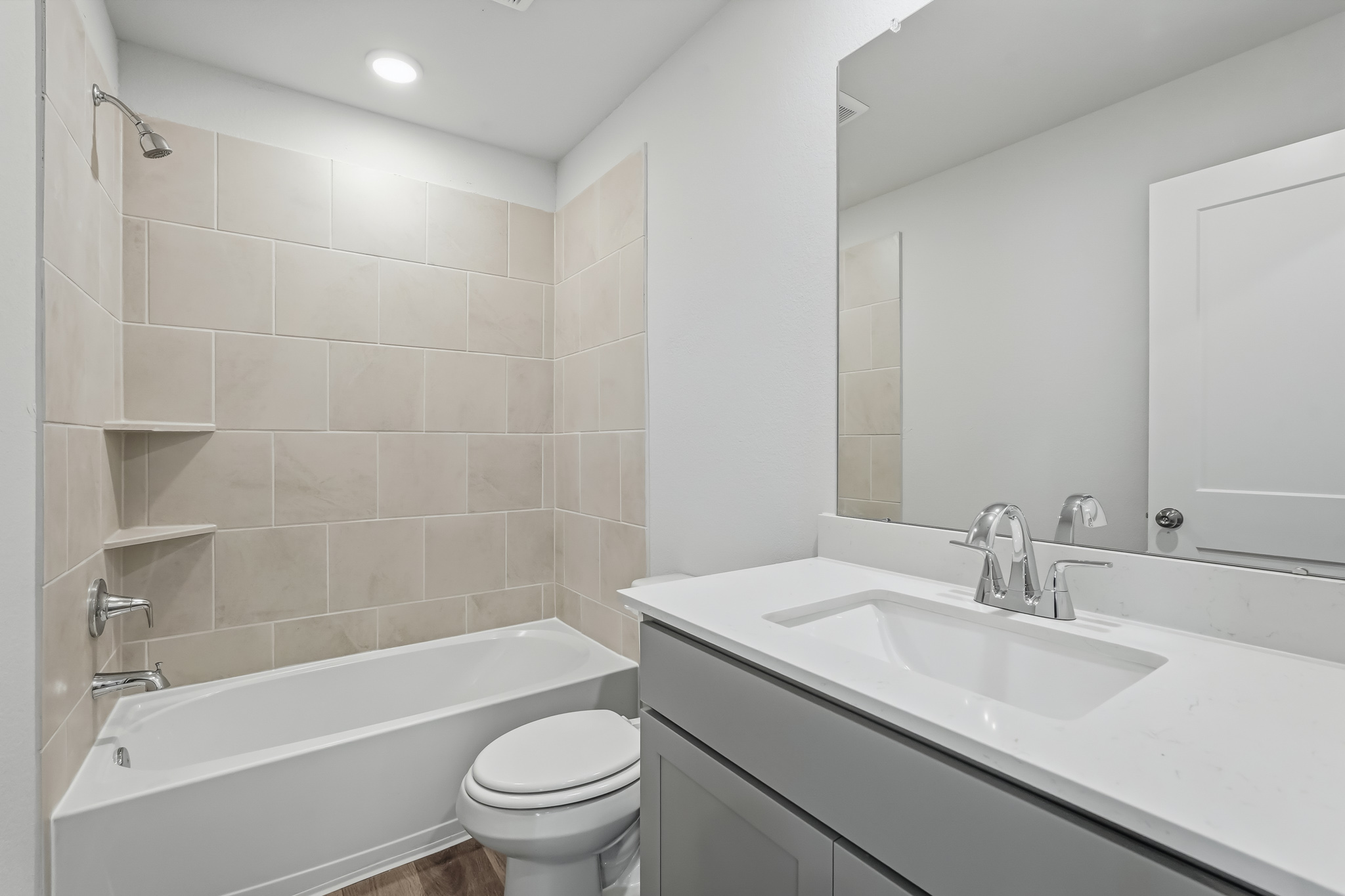 A bathroom with a tub sink and toilet.