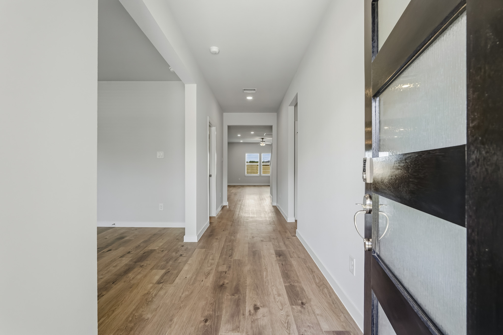 A hallway with white walls.