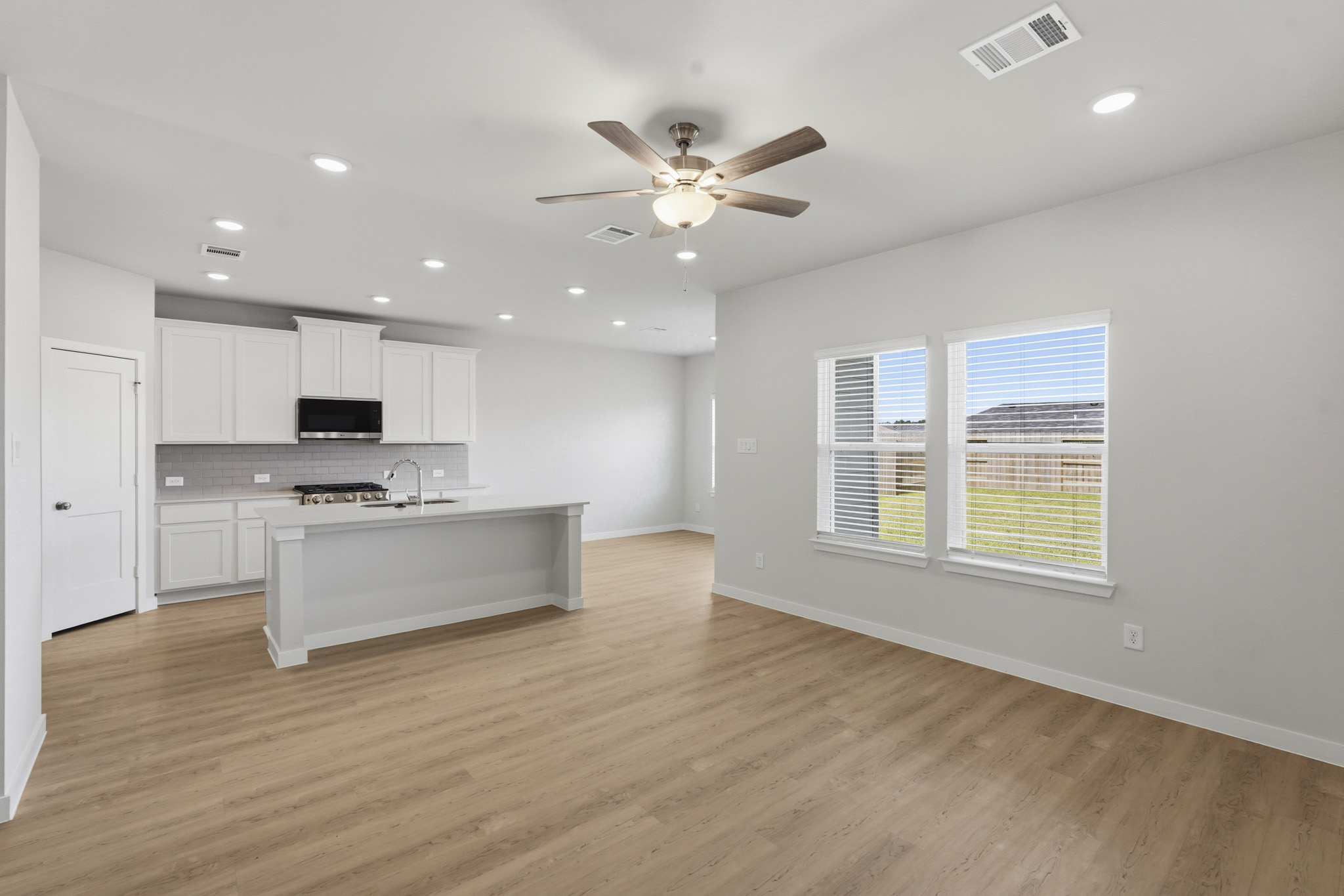 A kitchen with a wood floor.