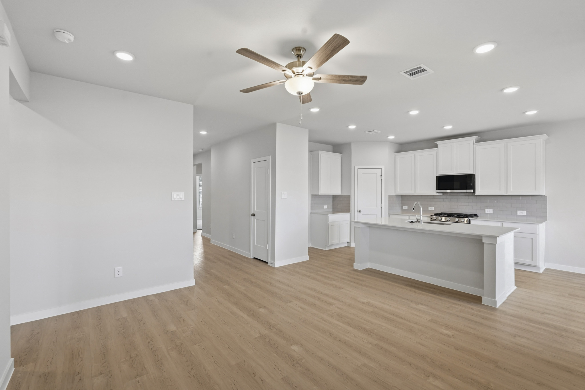 A large kitchen with white cabinets.
