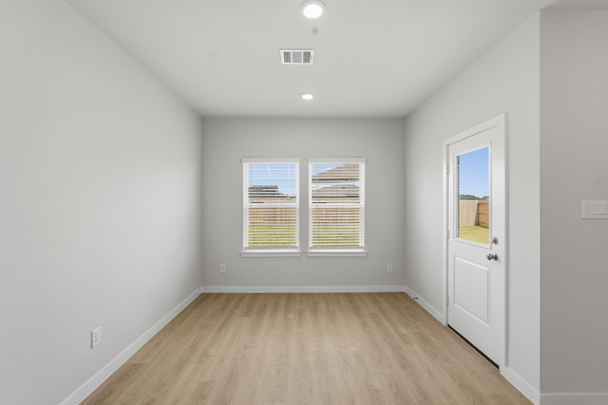 A room with a wood floor and white walls.