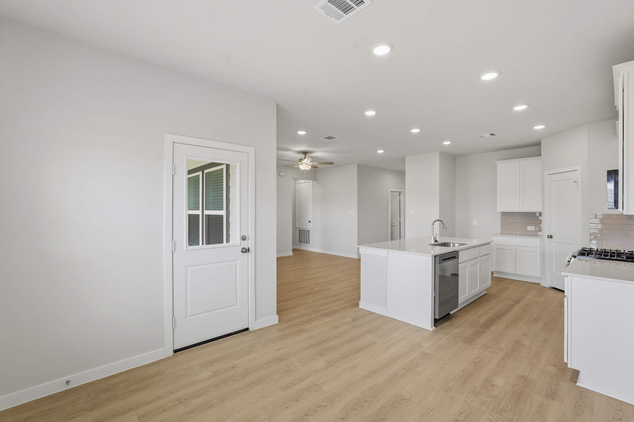 A kitchen with white cabinets.