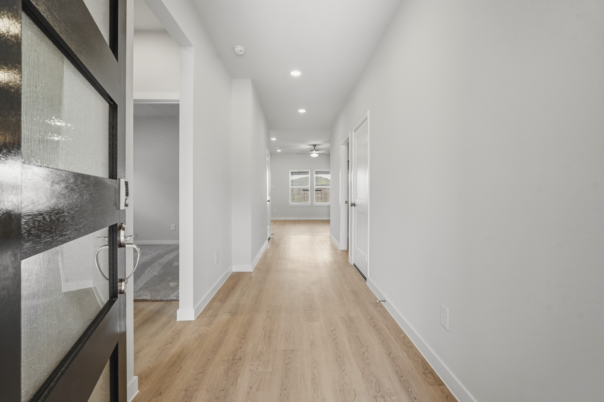 A hallway with white walls.