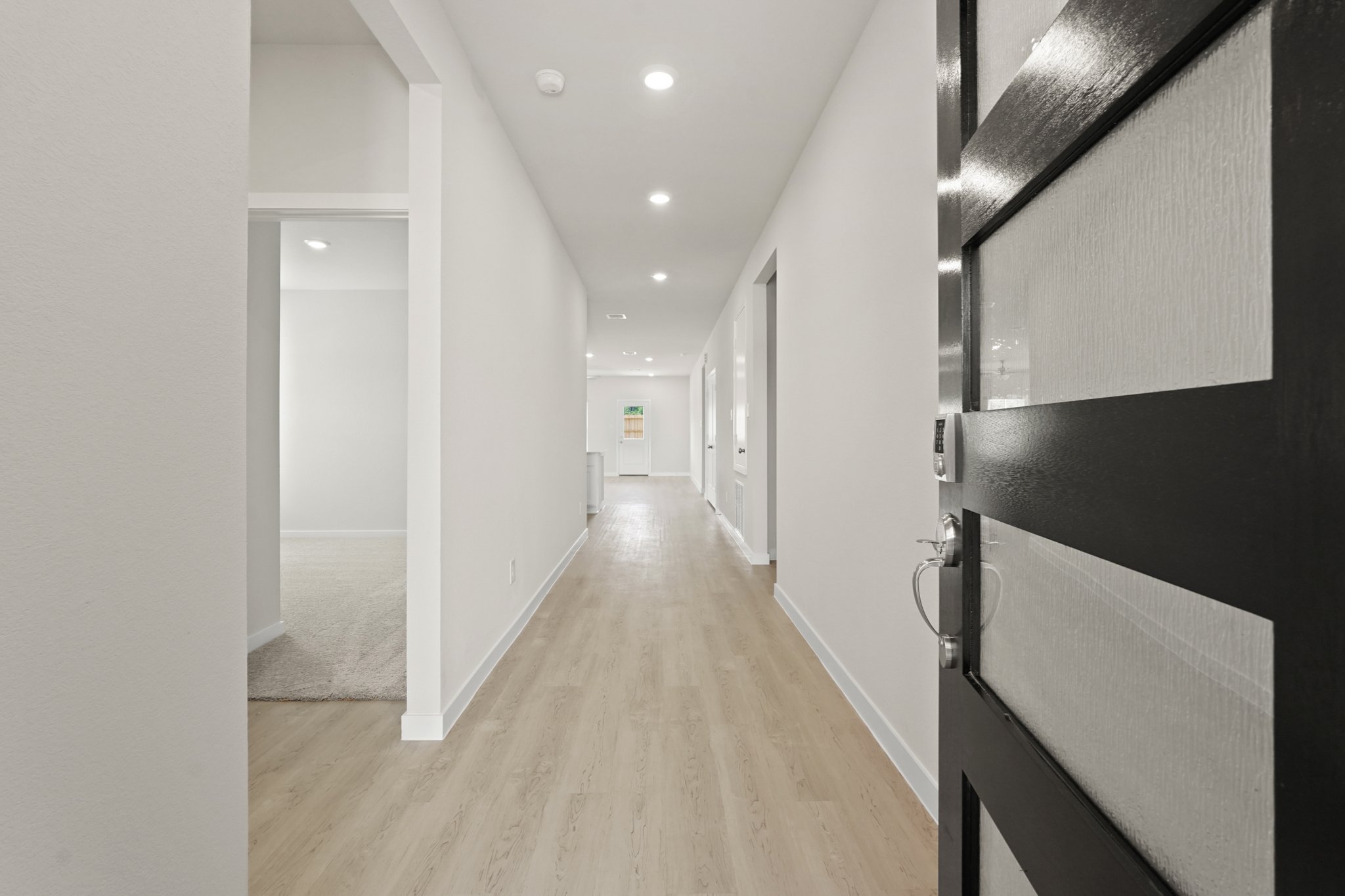 A hallway with white walls.
