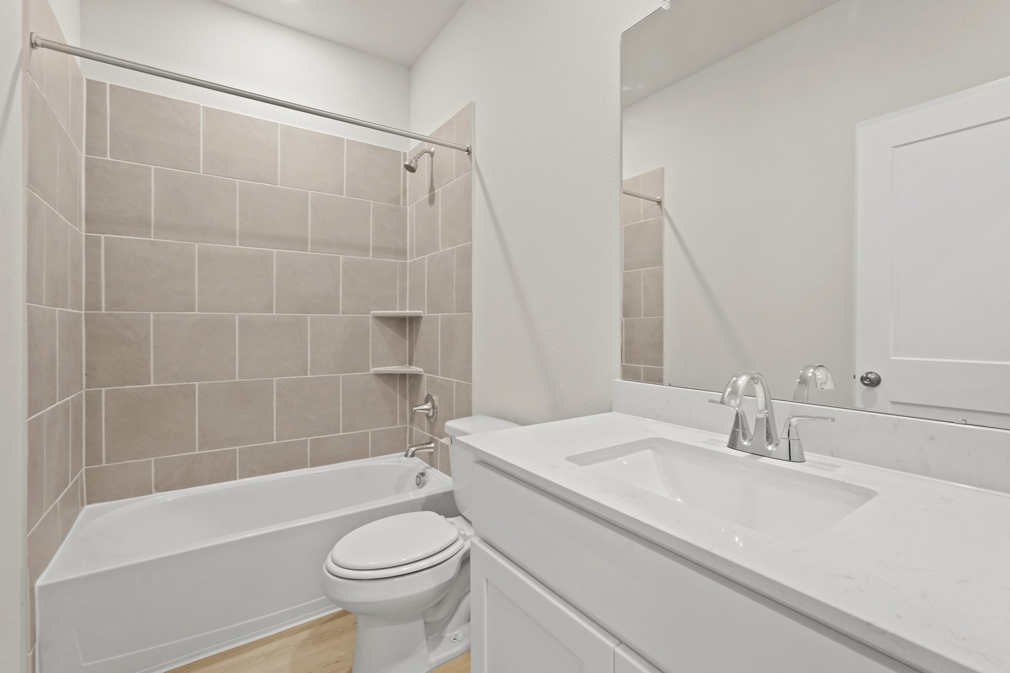 A bathroom with a tub sink and toilet.