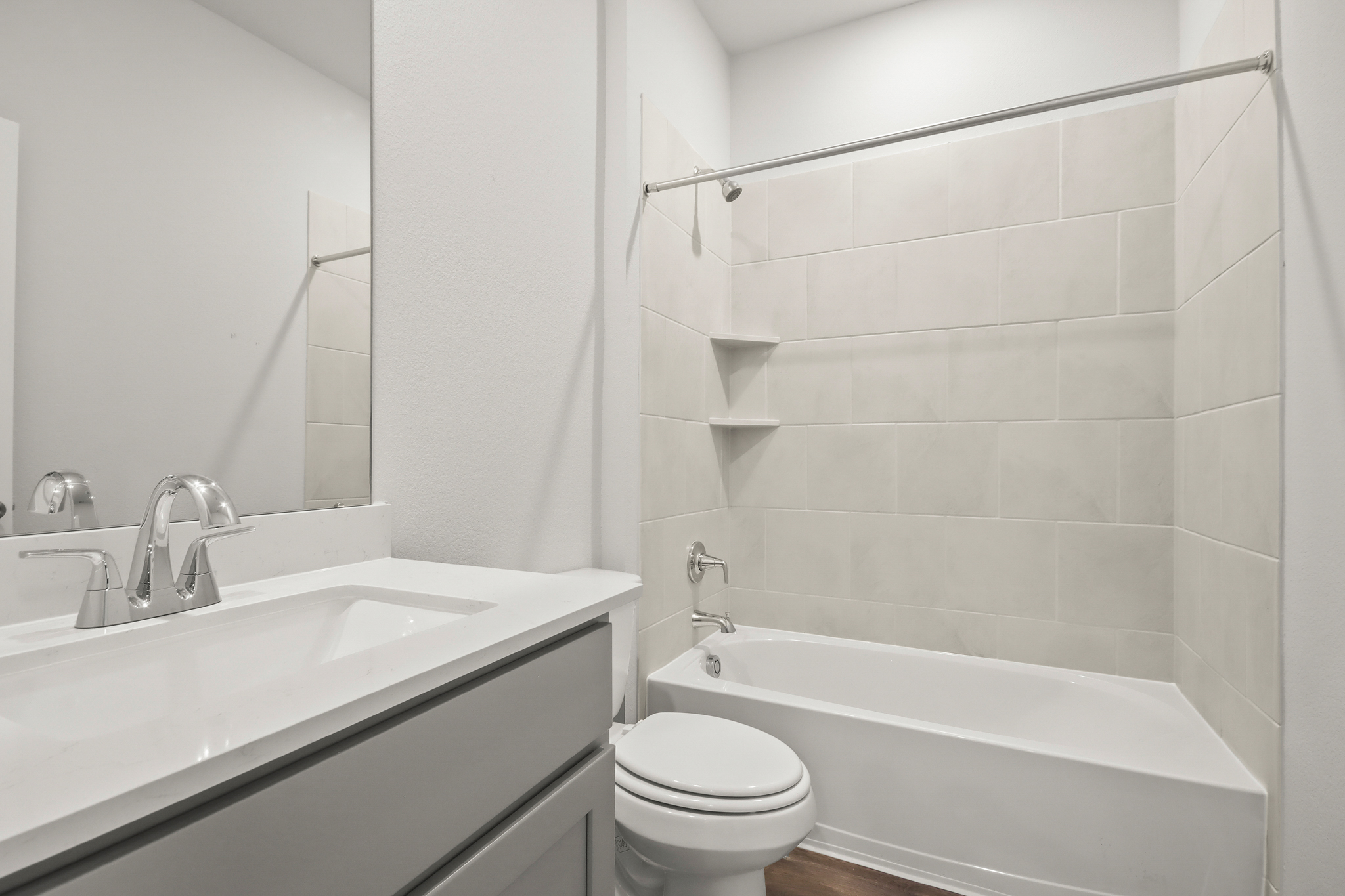 A bathroom with a tub sink and toilet.