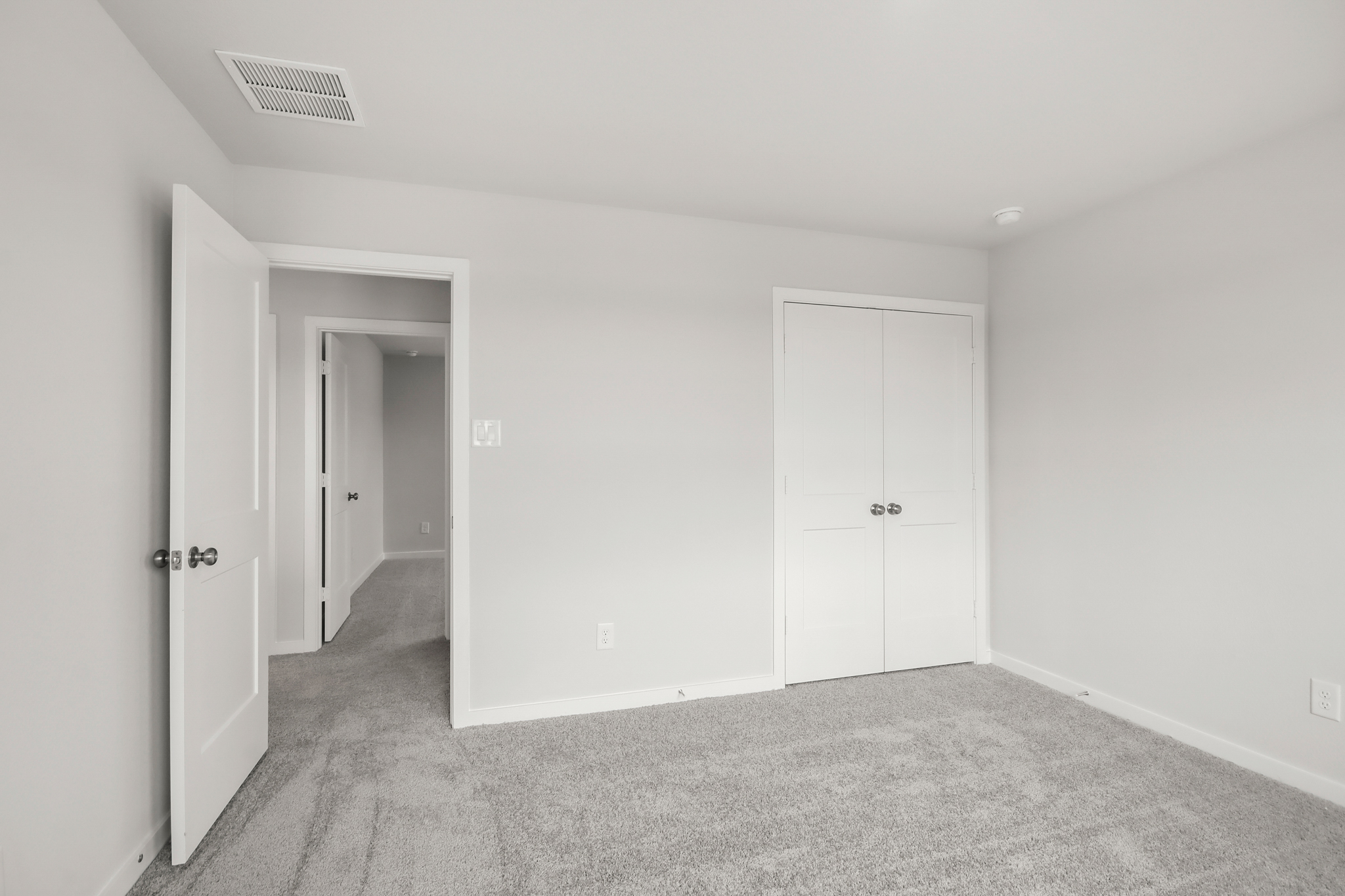 A hallway with white doors.