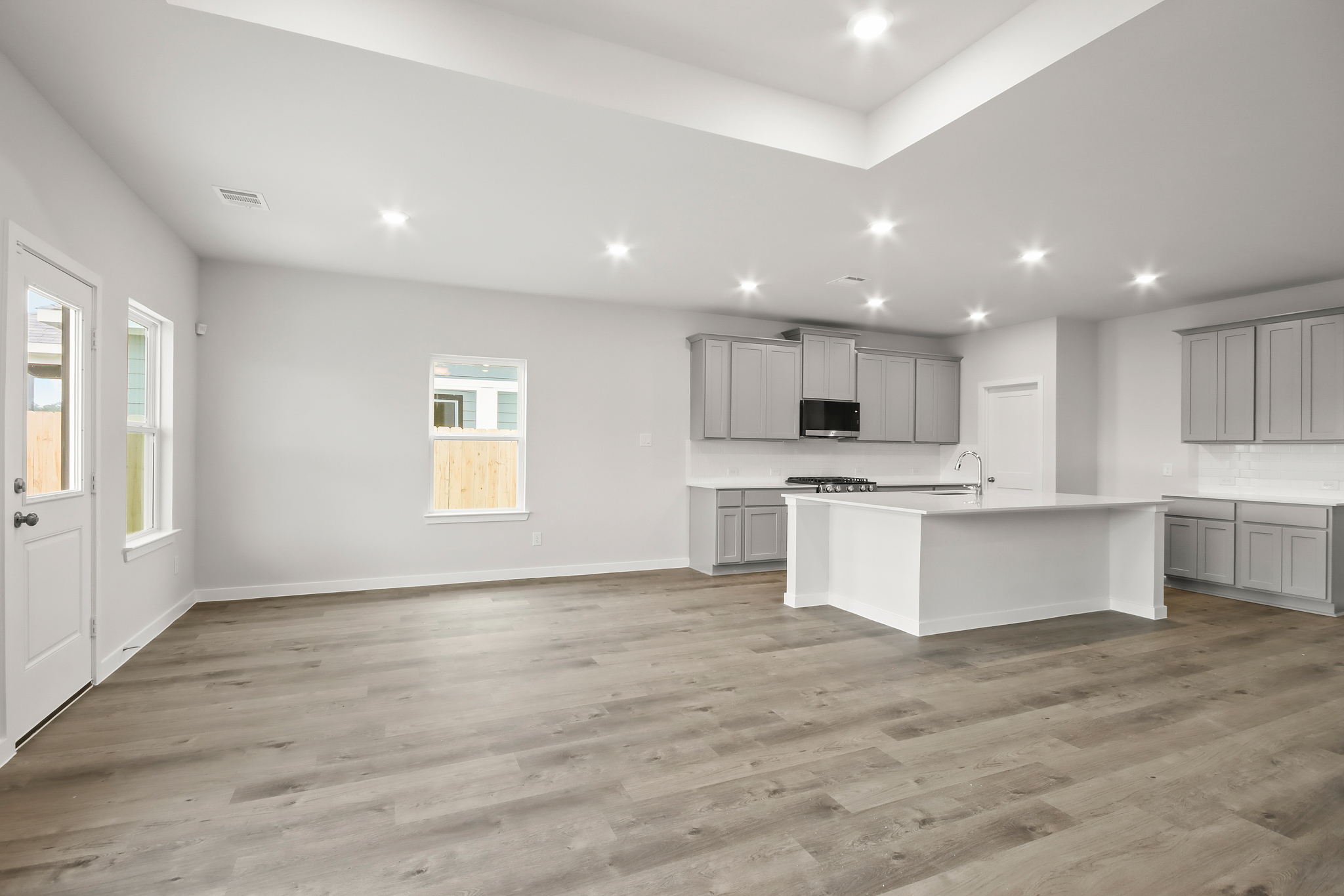 A kitchen with white cabinets.