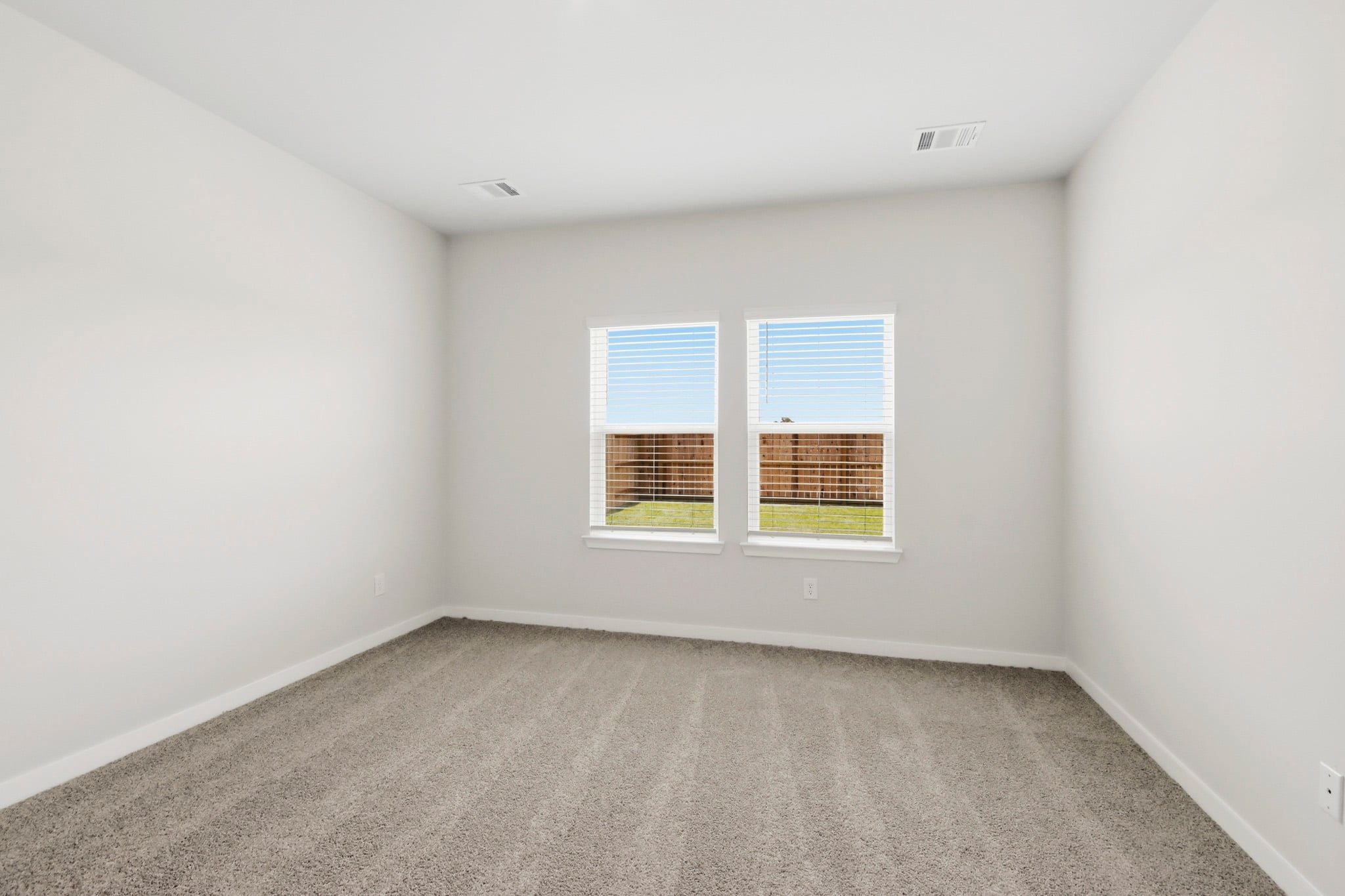 A room with a window and carpet.