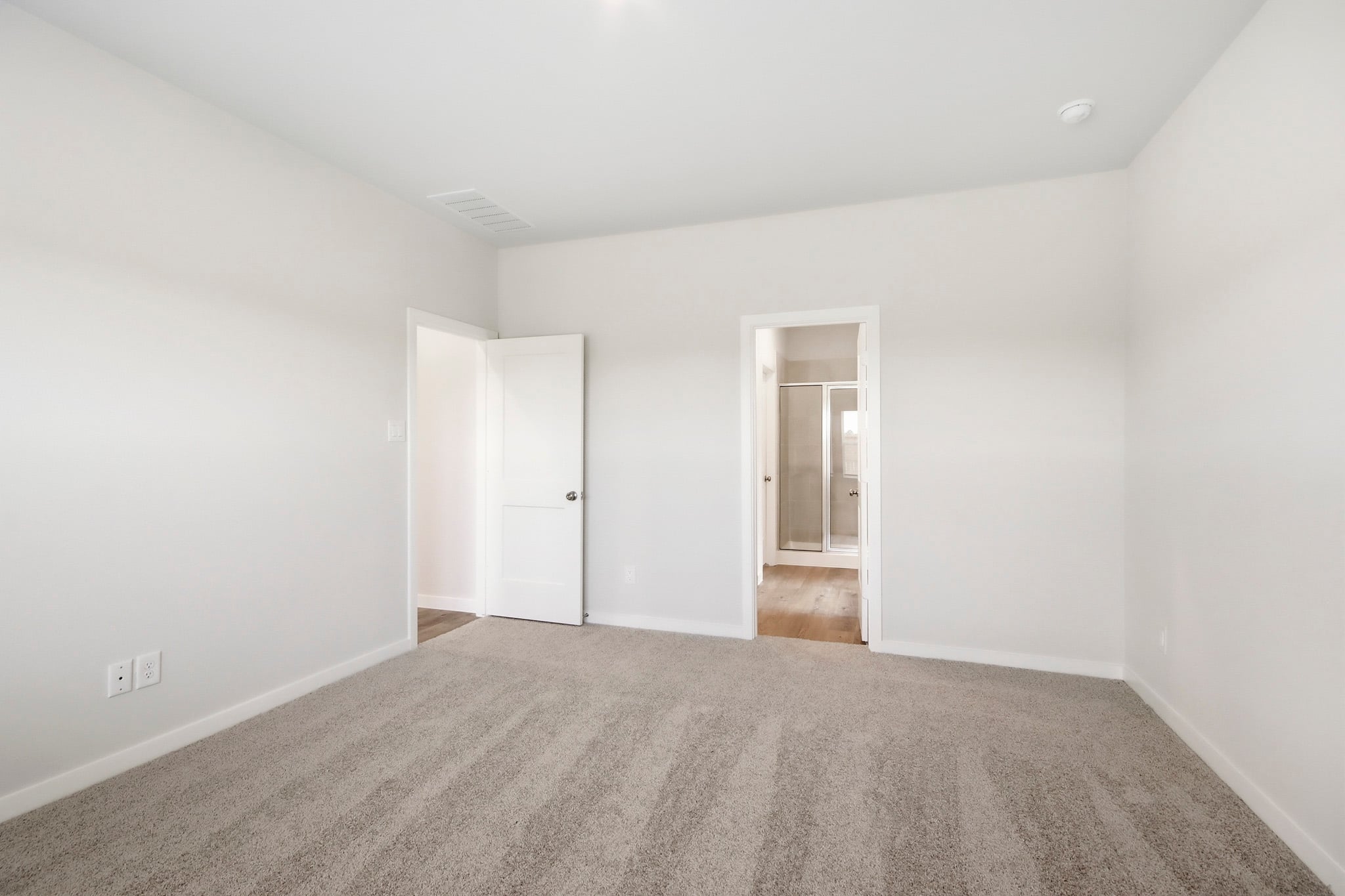 A hallway with white walls.