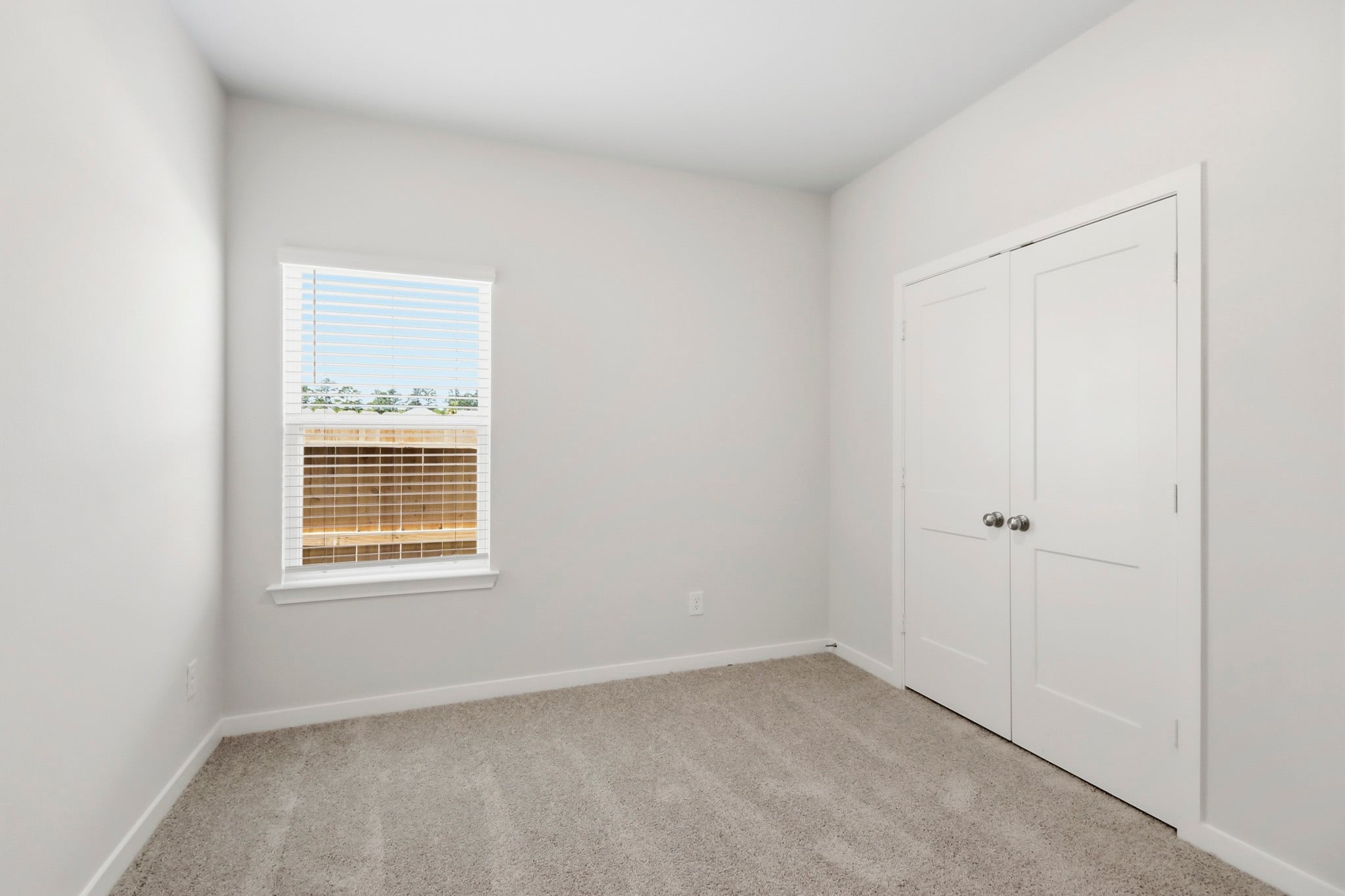 A room with white doors and a window.