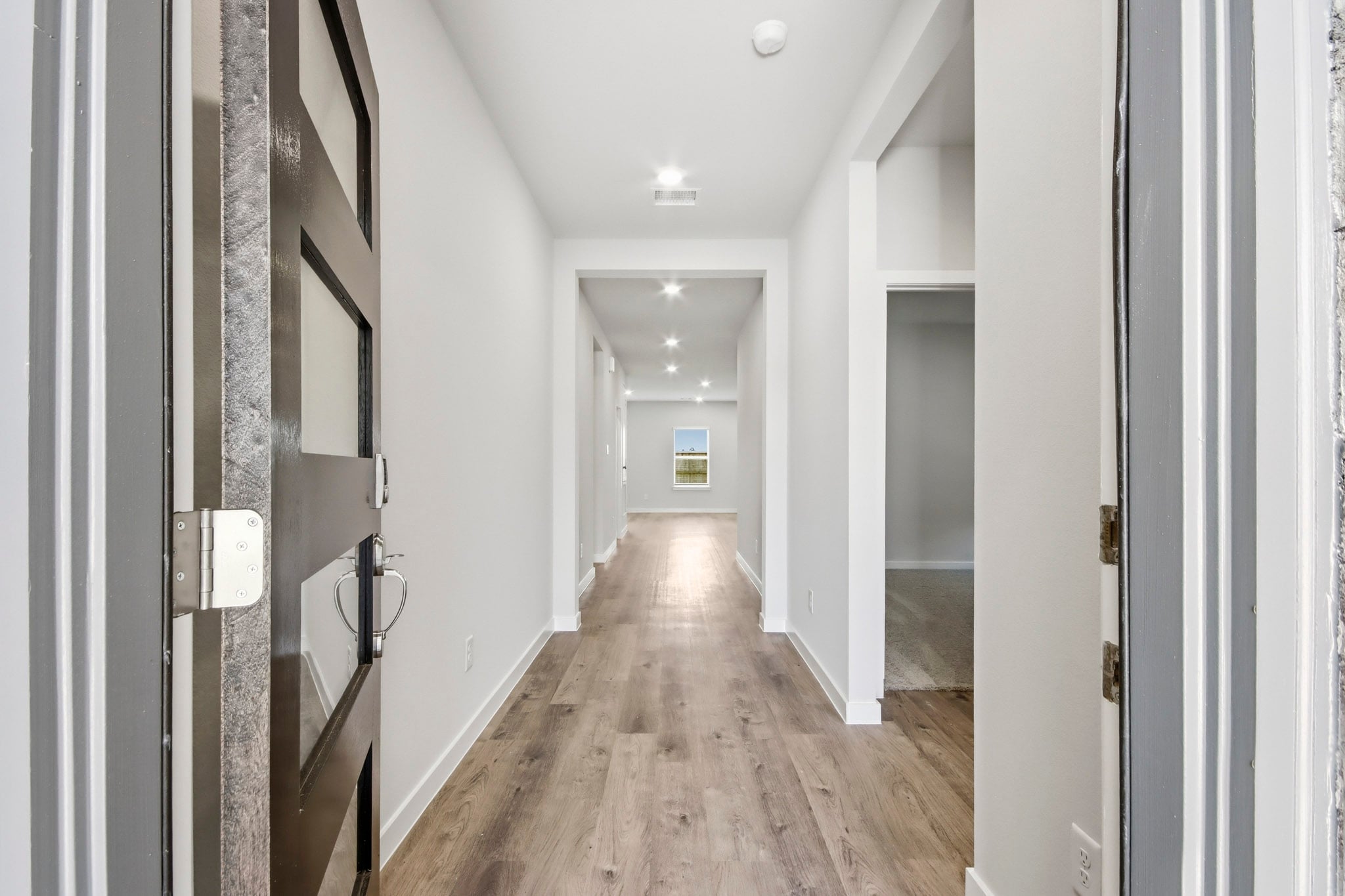 A hallway with white walls.