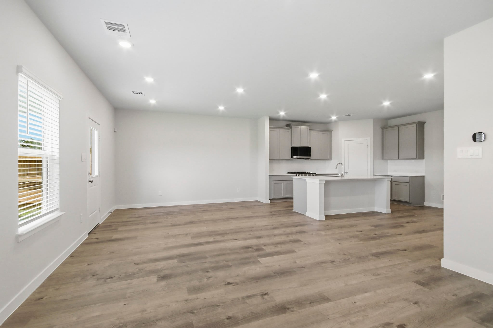 A kitchen with white cabinets.