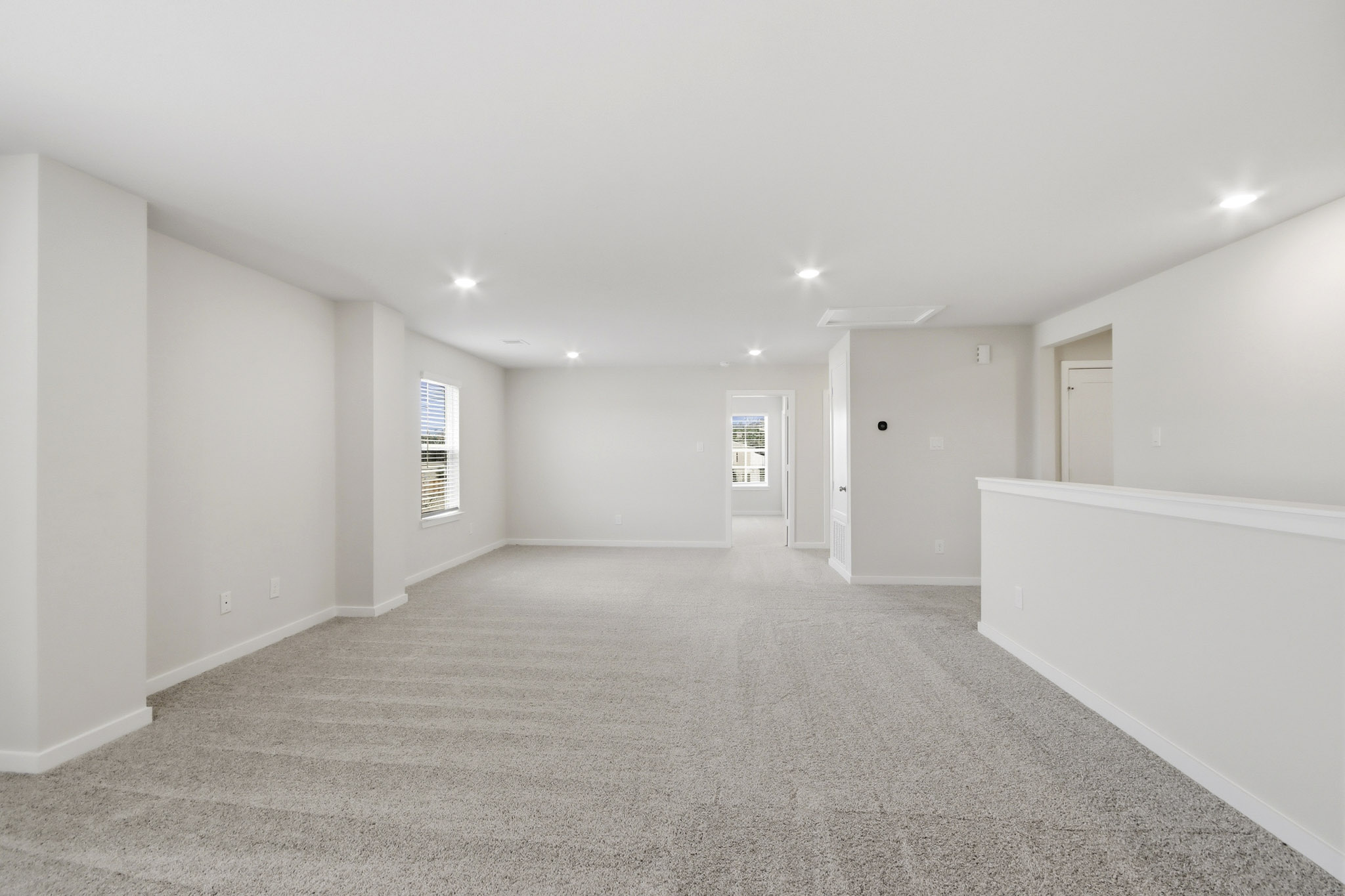 A long hallway with white walls.