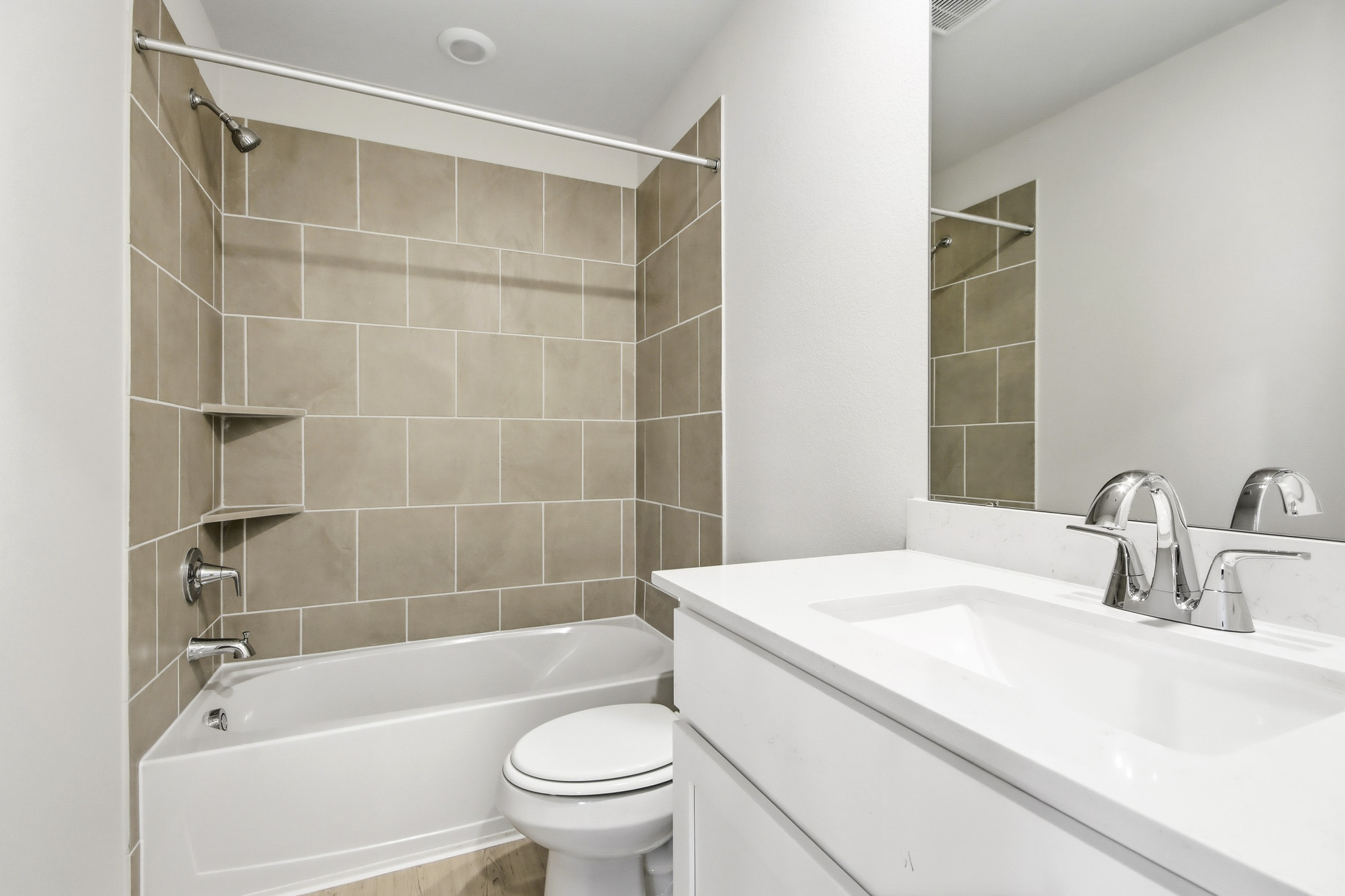 A bathroom with a tub sink and toilet.
