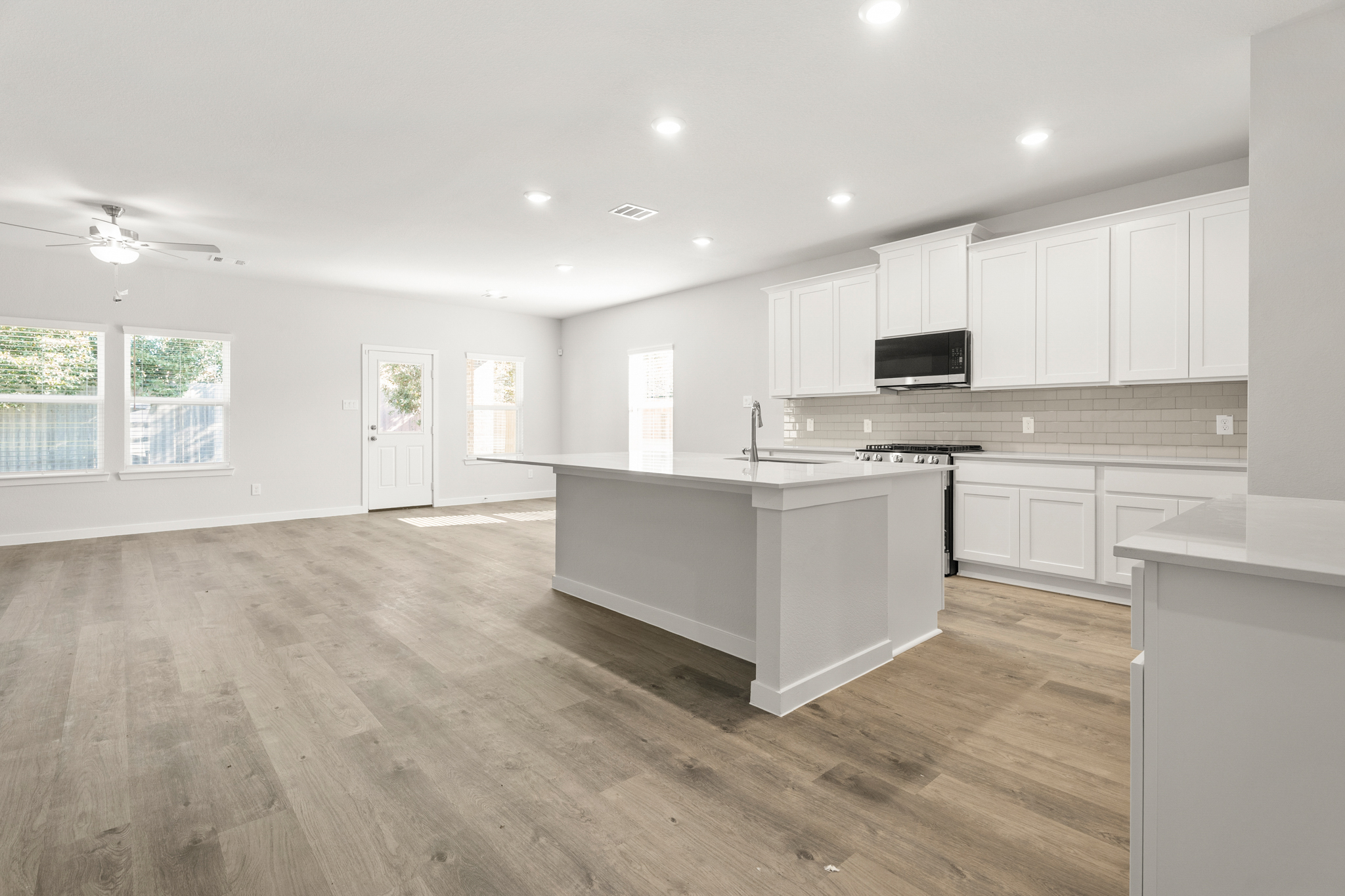 A kitchen with white cabinets.