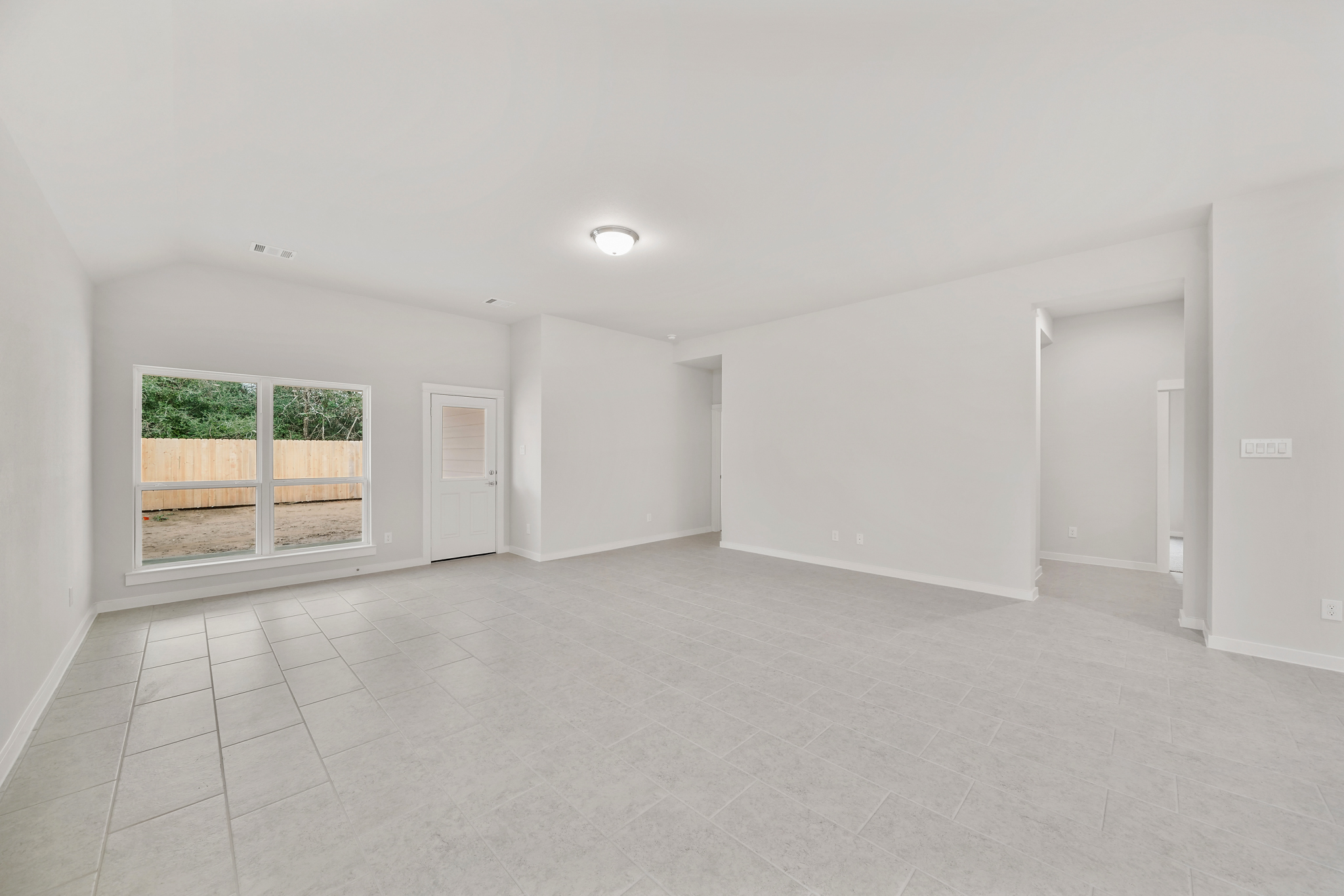 A room with white walls and a window.