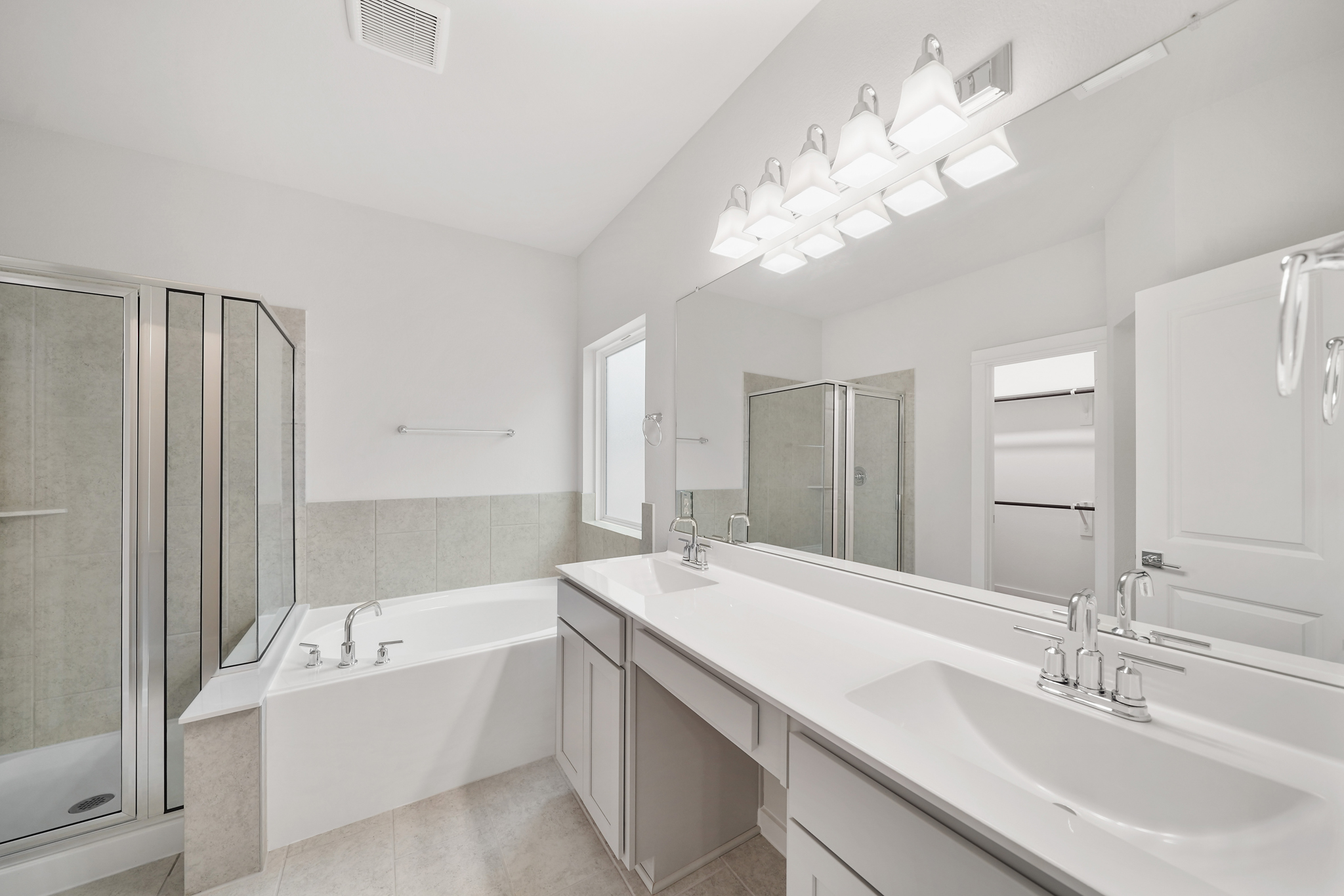 A bathroom with a large mirror.