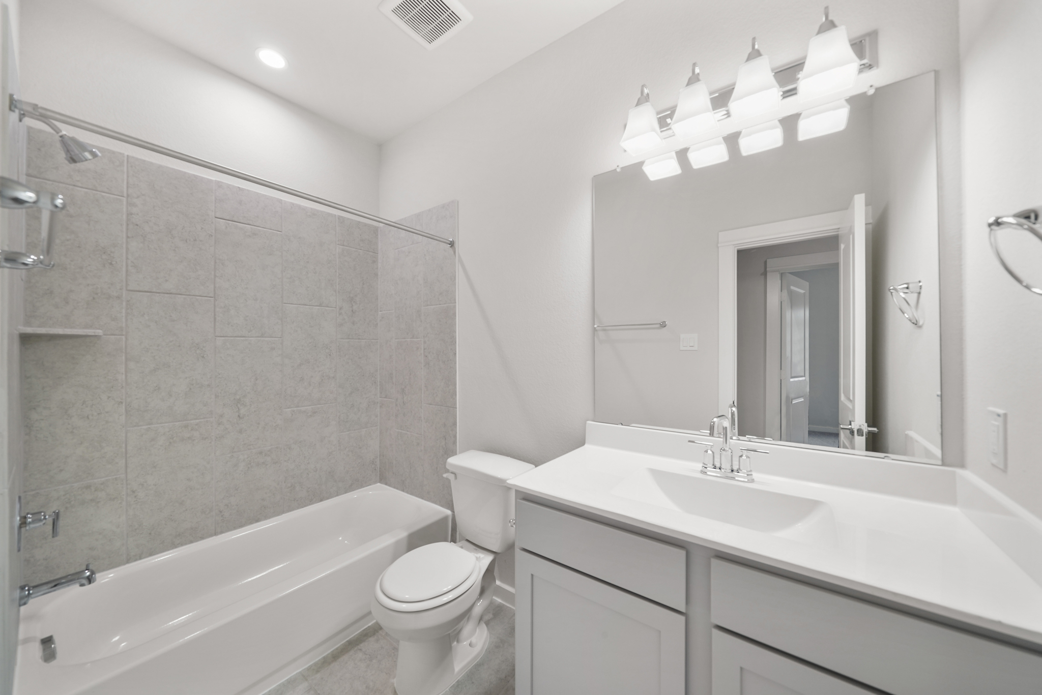A bathroom with a tub sink and toilet.