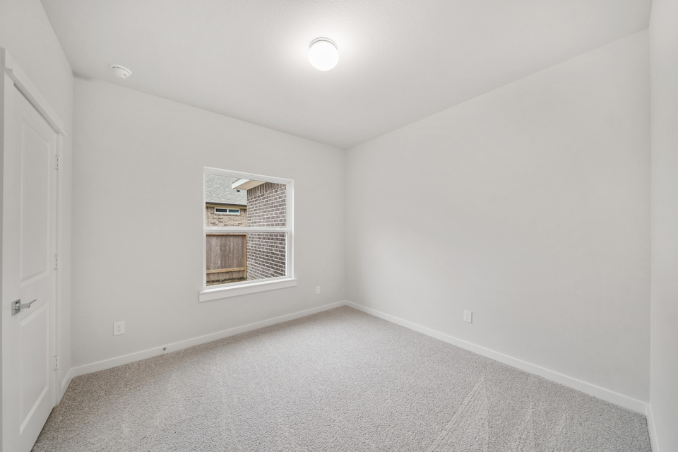 A room with a window and a door.