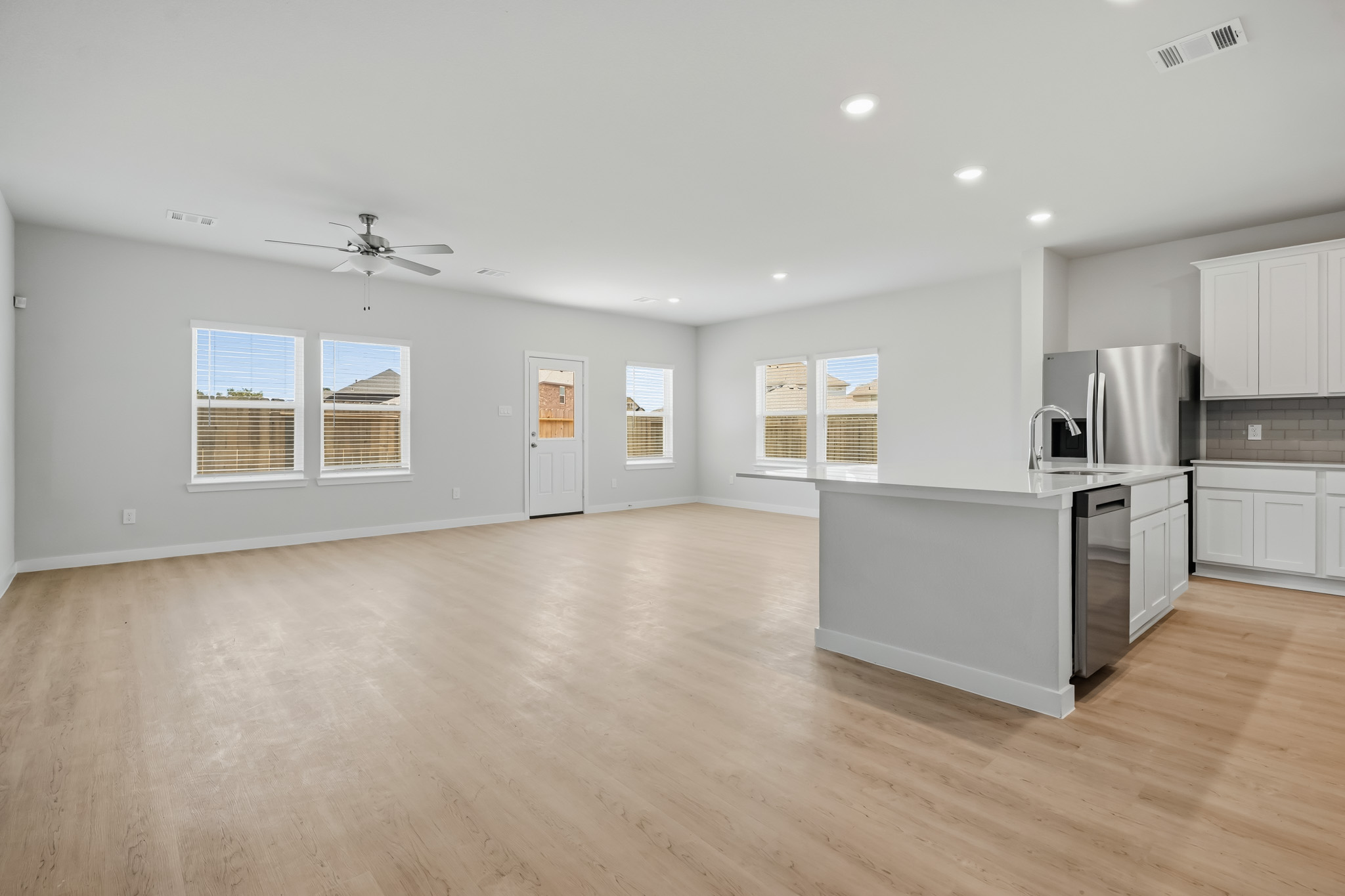 A large kitchen with white cabinets.