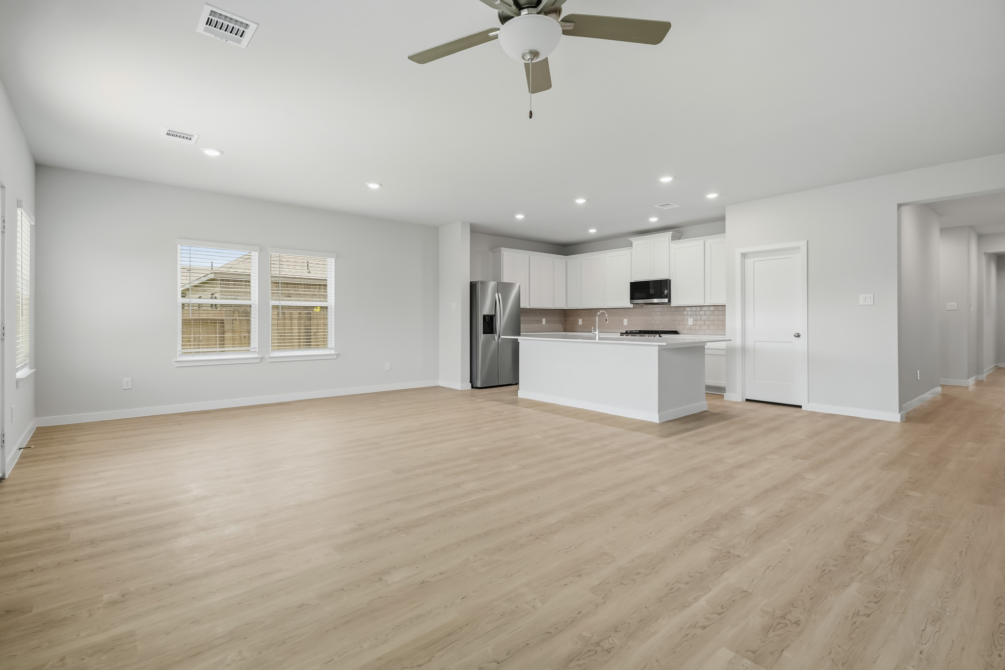 A large kitchen with a wood floor.