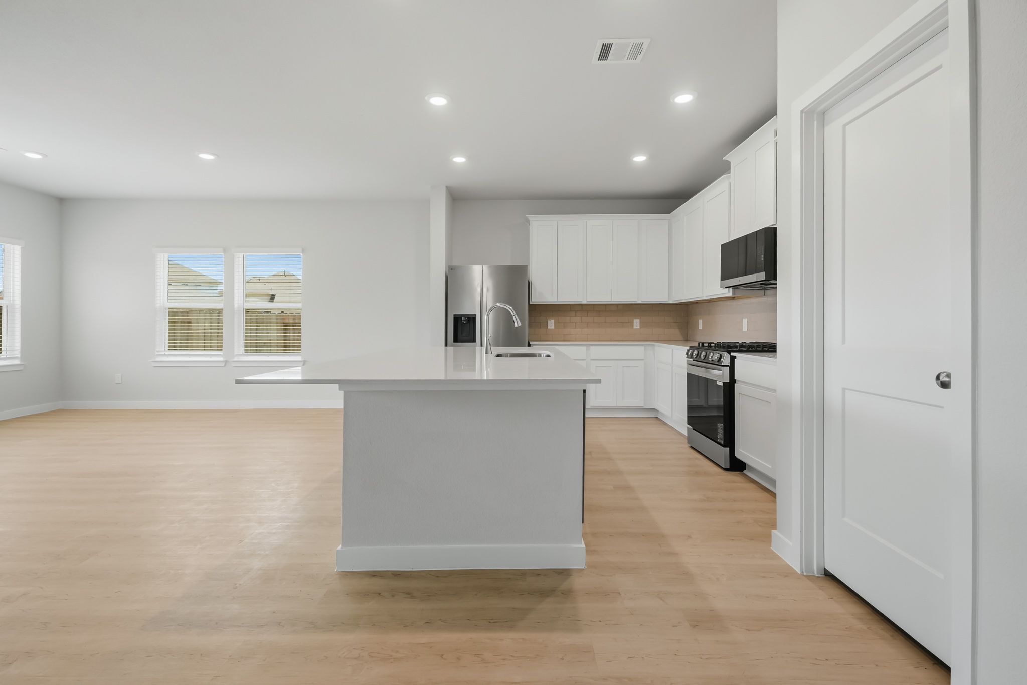 A kitchen with white cabinets.