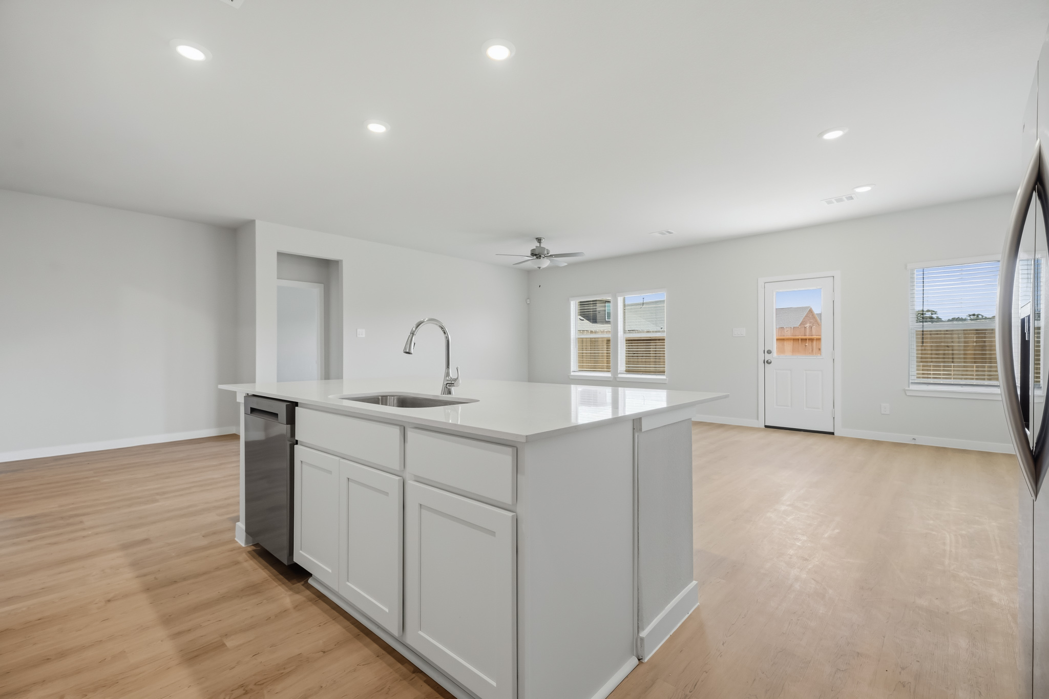 A kitchen with white cabinets.