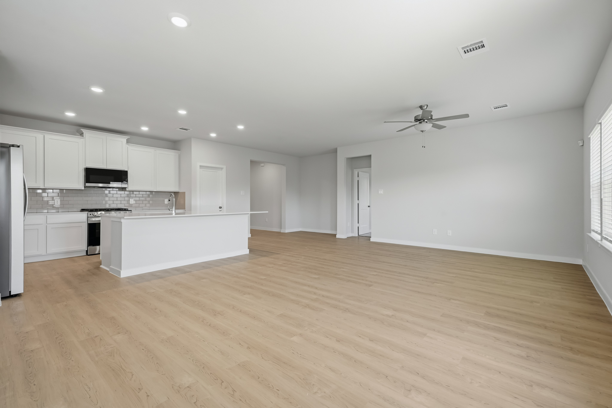 A large kitchen with white cabinets.