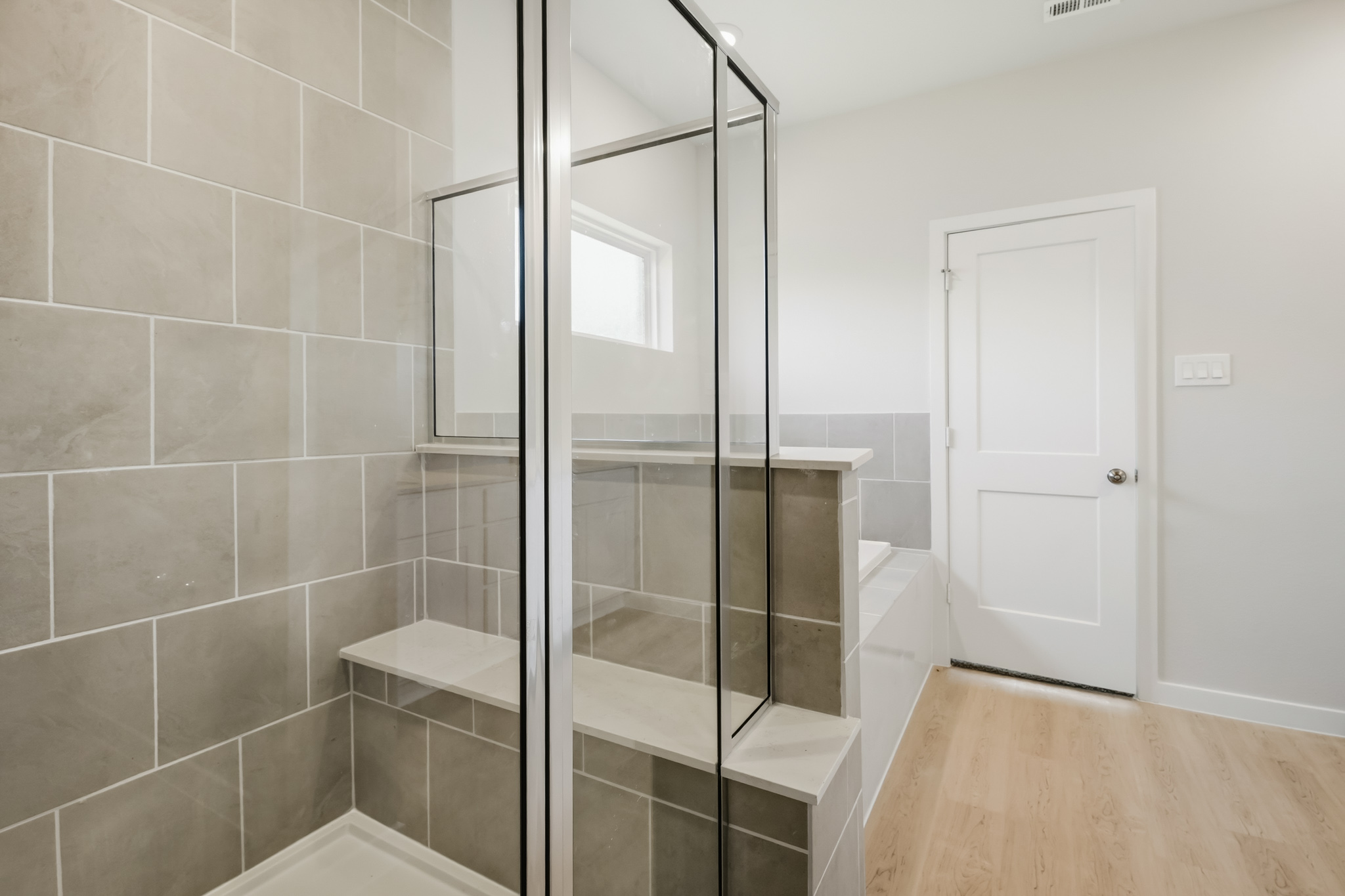 A bathroom with a glass shower.