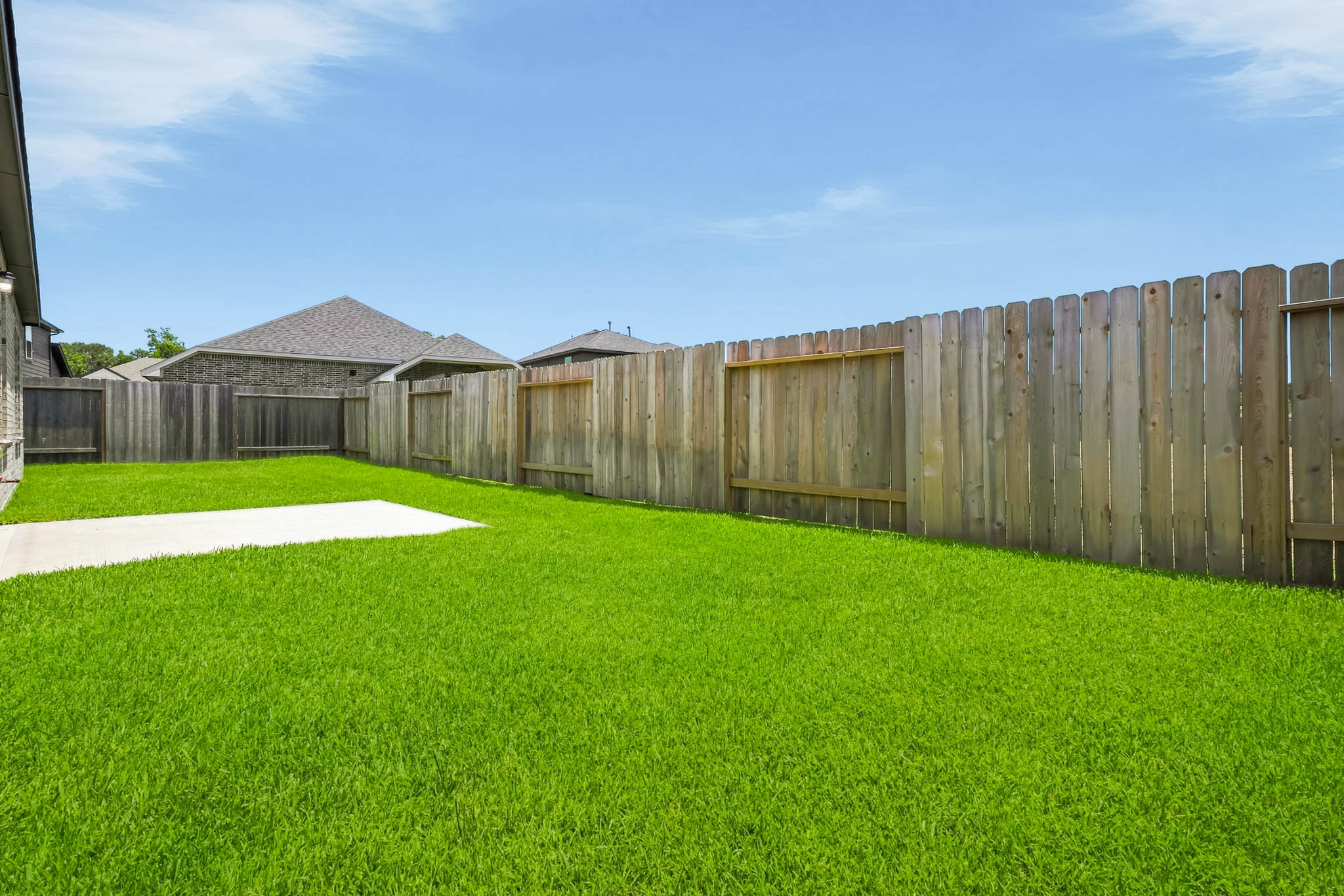 A row of wooden buildings with Nelson-Atkins Museum of Art in the background.