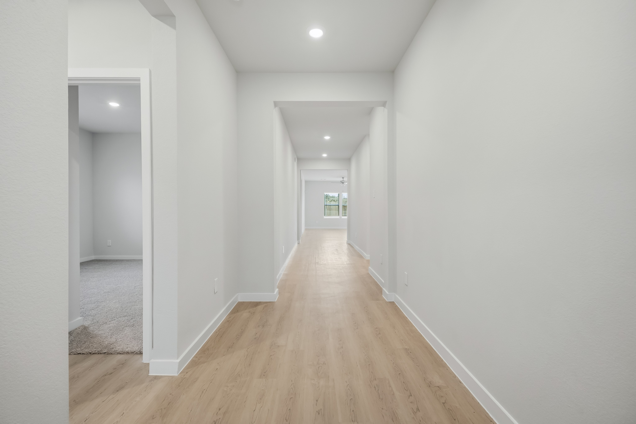 A hallway with white walls.