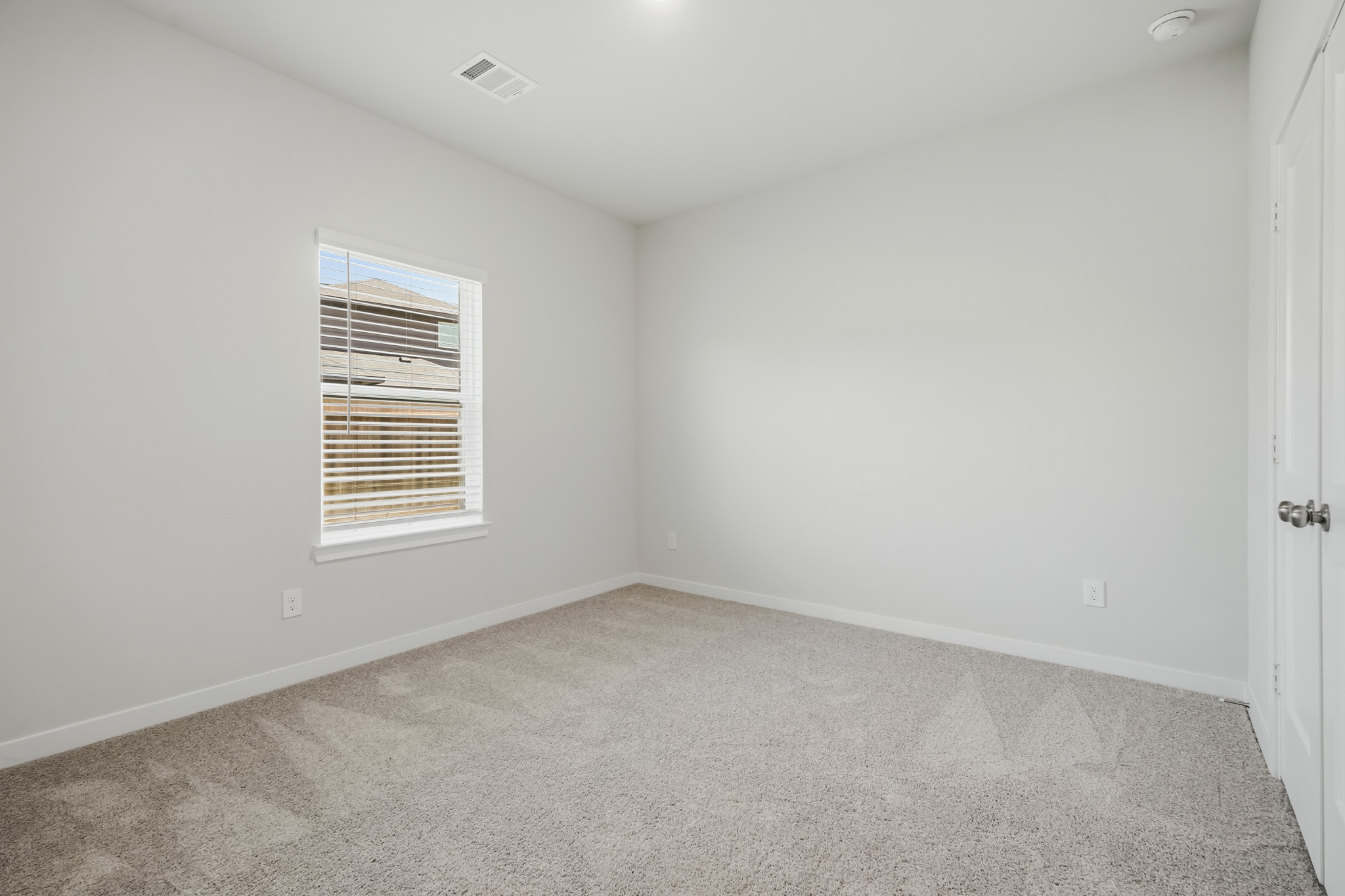A room with a window and a door.