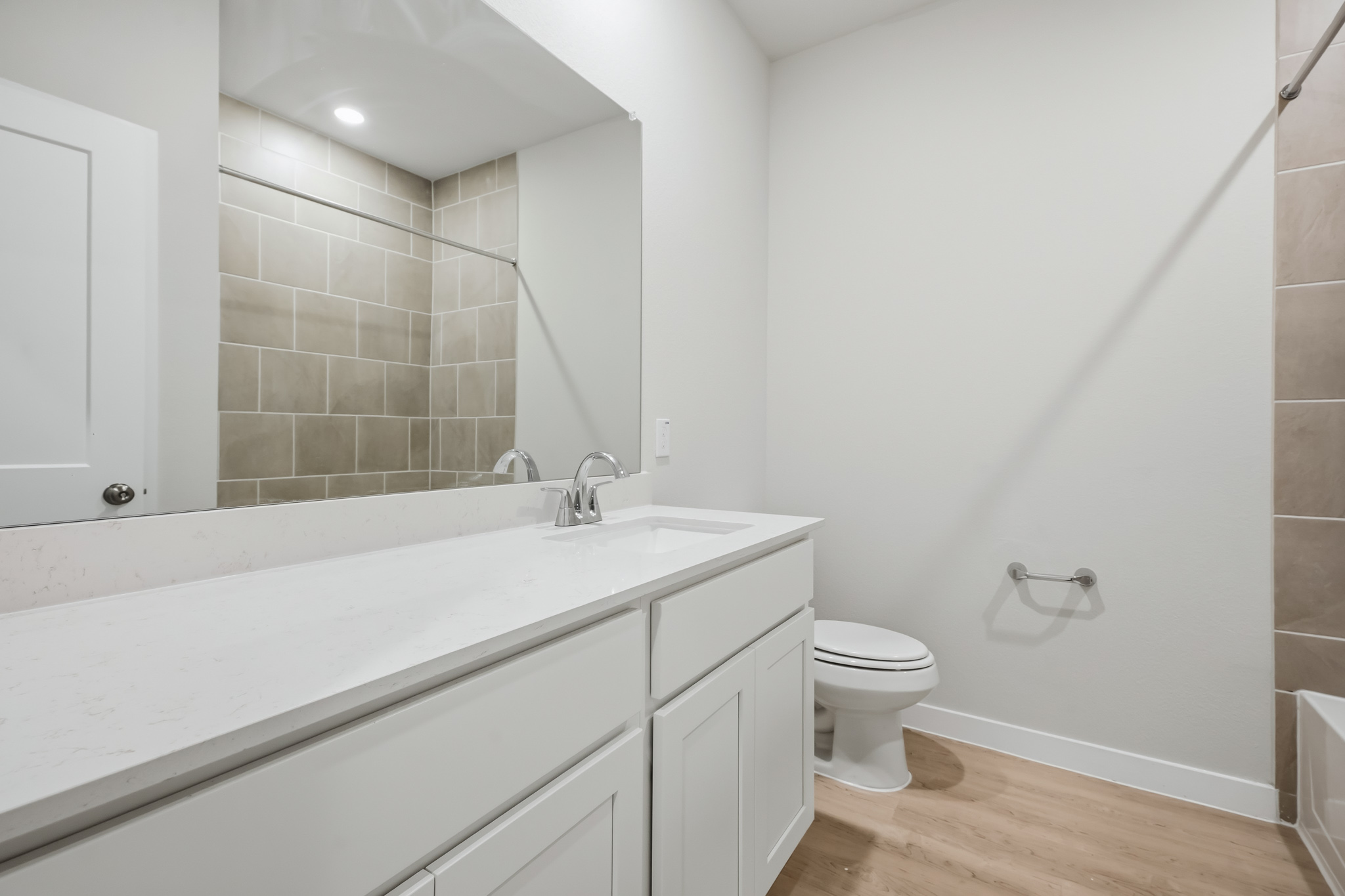 A bathroom with a tub toilet and sink.