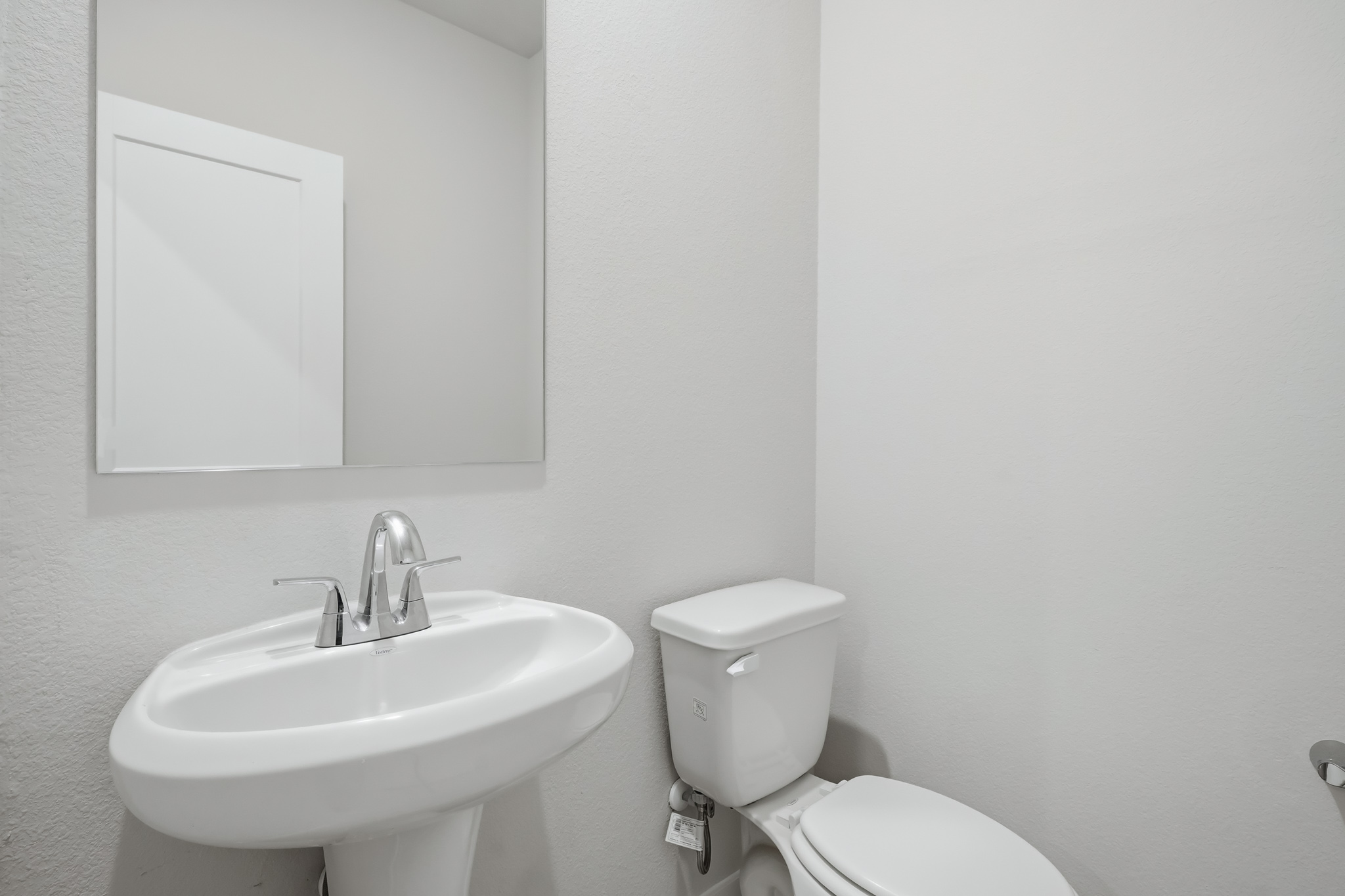 A bathroom with a toilet and sink.