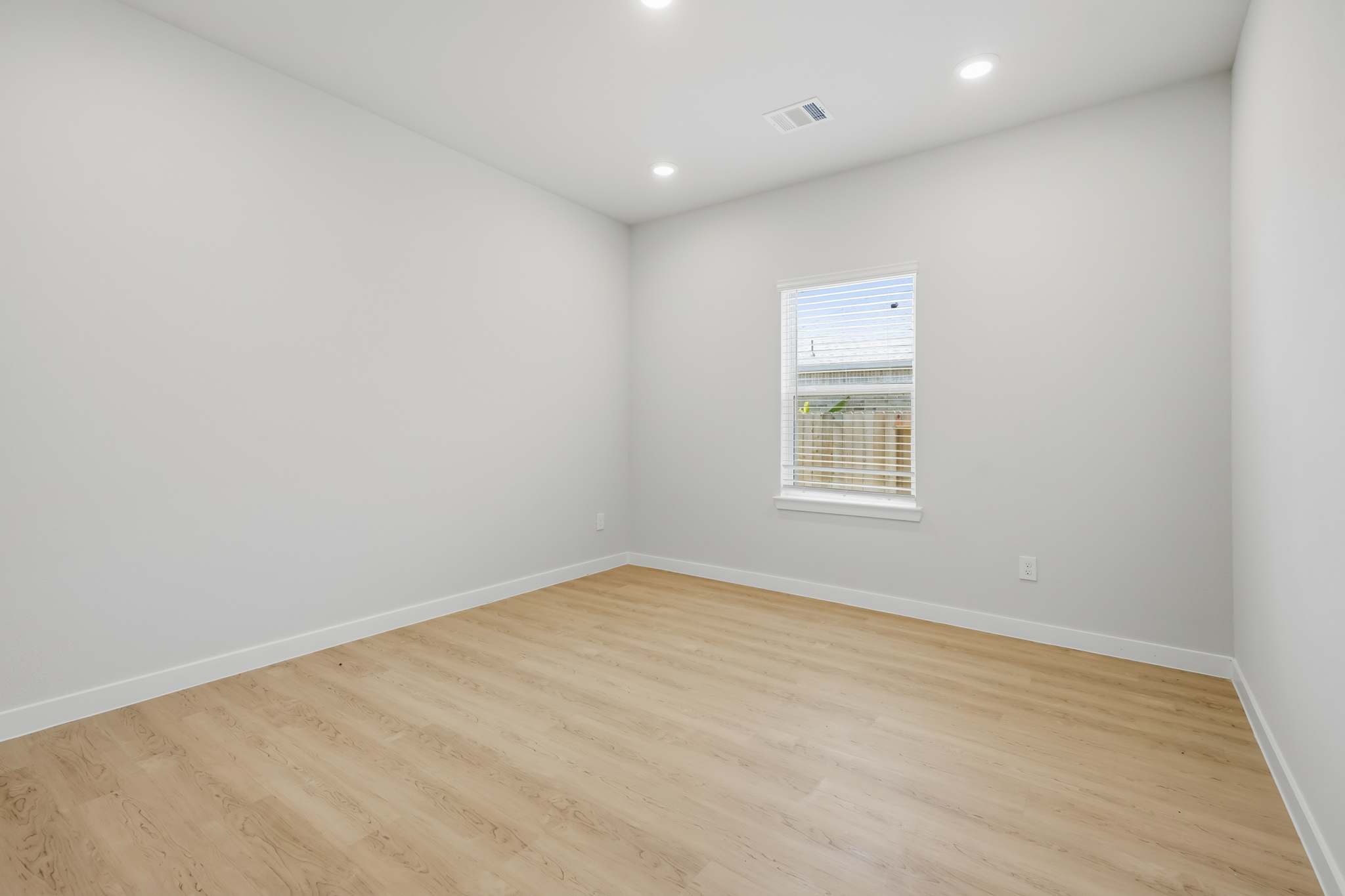 A room with a wood floor and a wood floor.