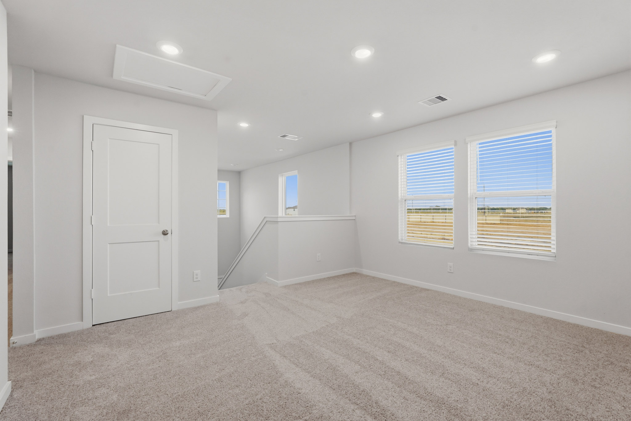 A room with a door and windows.