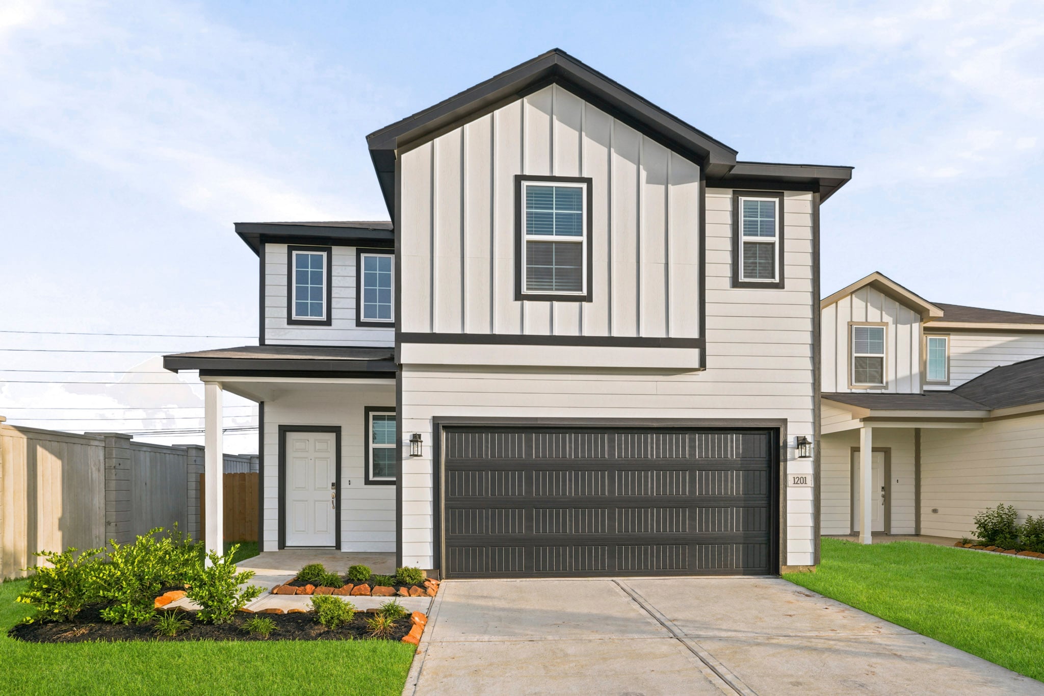 A grey house with a garage.