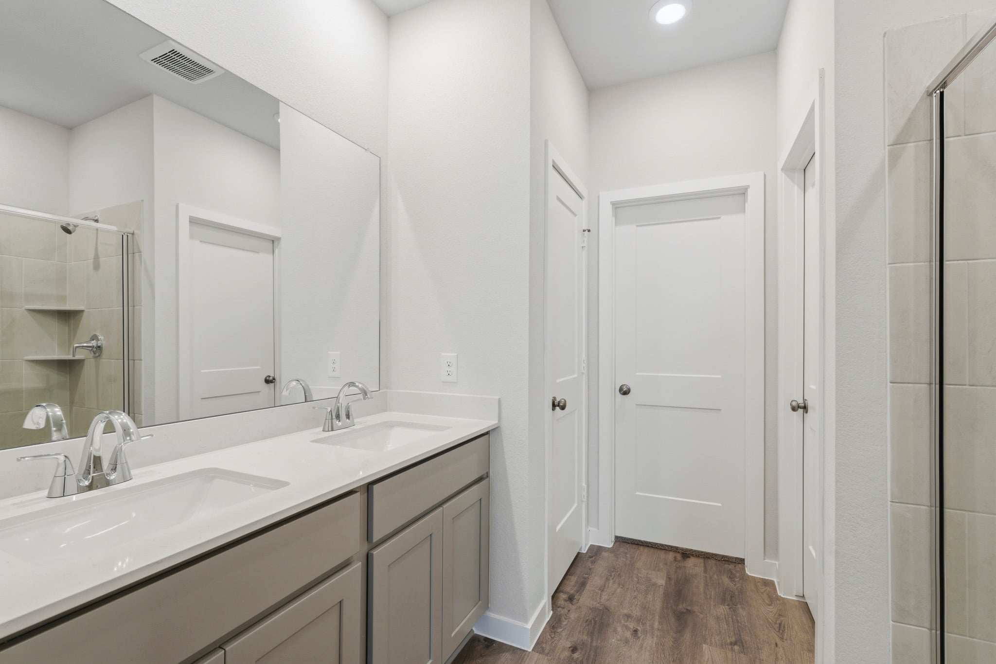A bathroom with a large mirror.