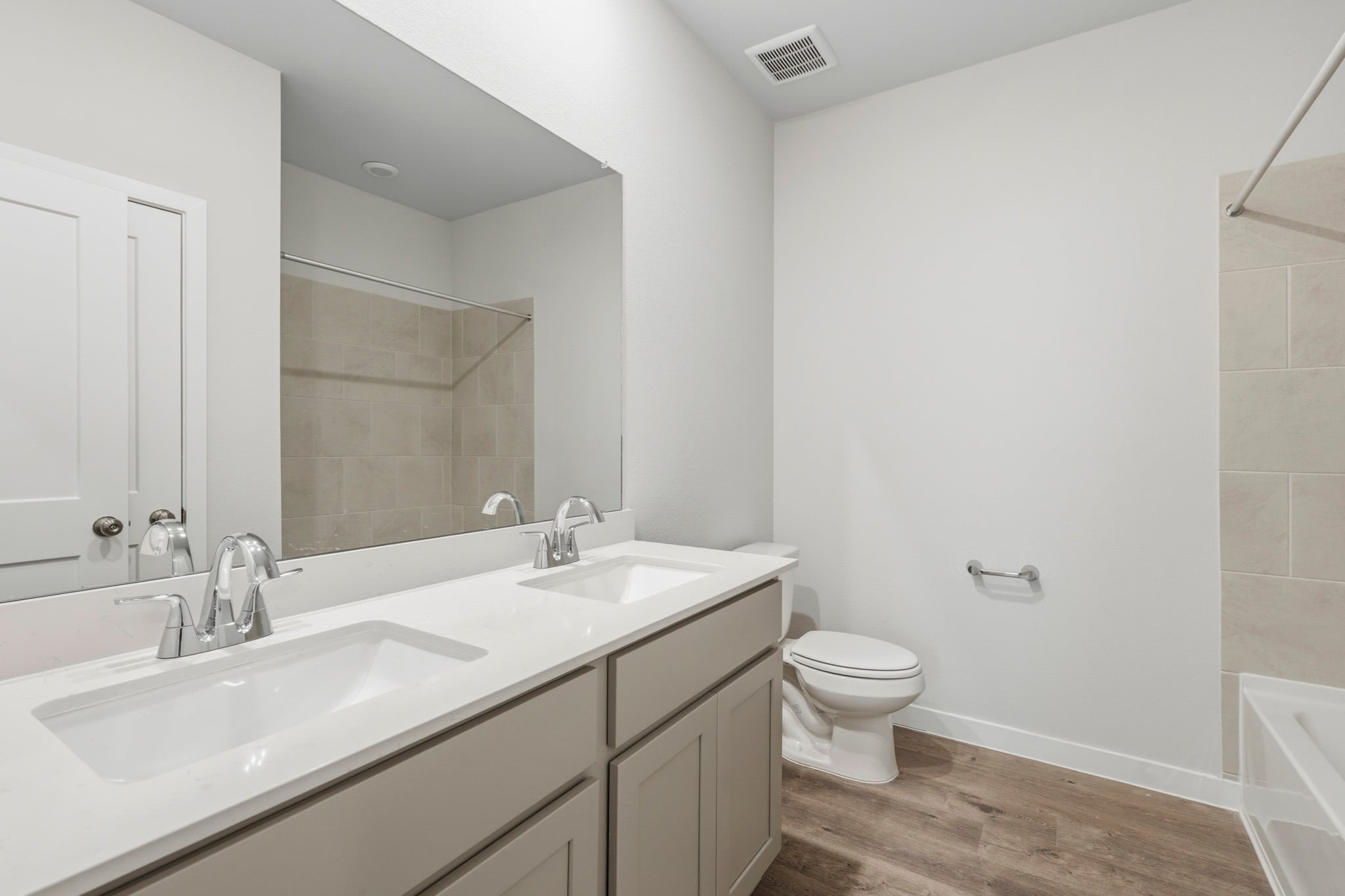 A bathroom with a tub sink and toilet.