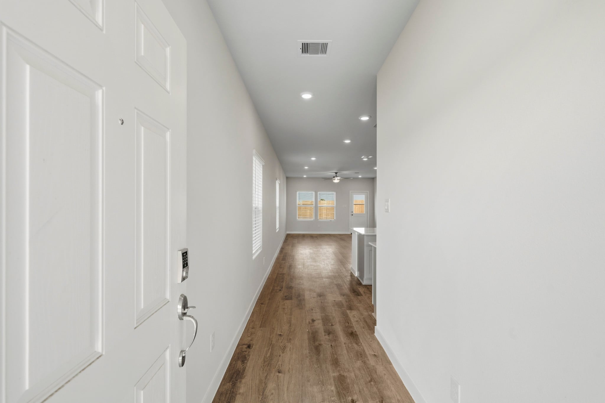 A hallway with white doors.