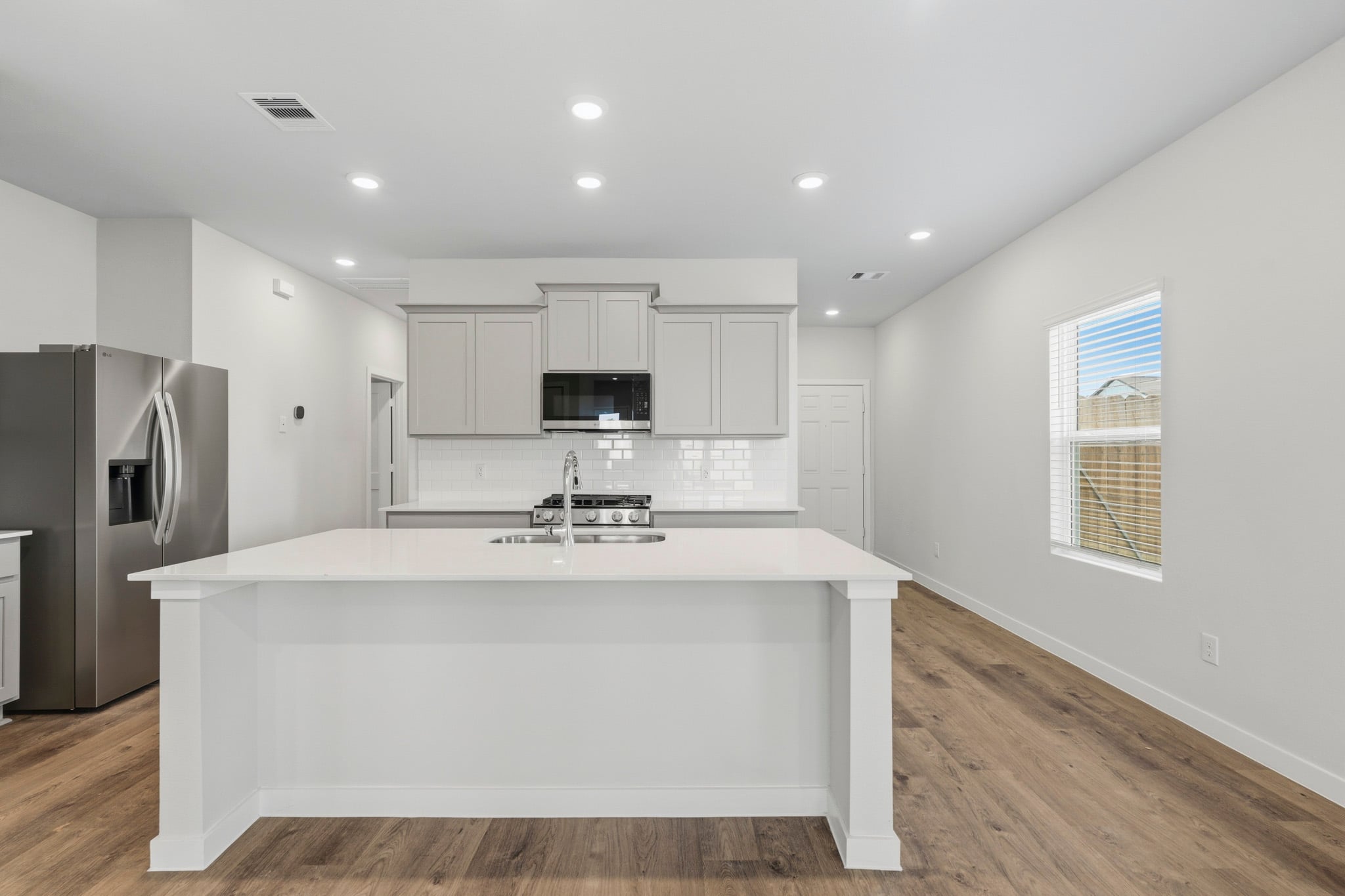 A kitchen with white cabinets.