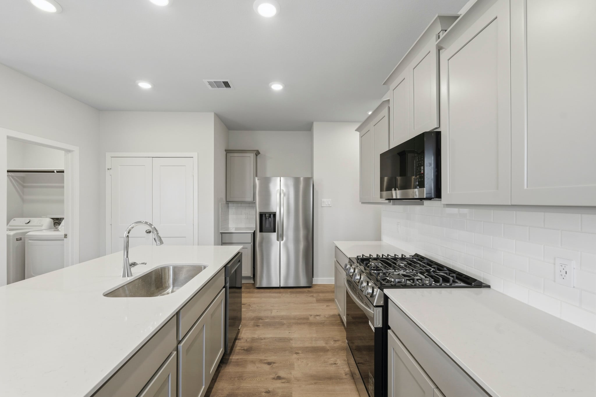 A kitchen with white cabinets.