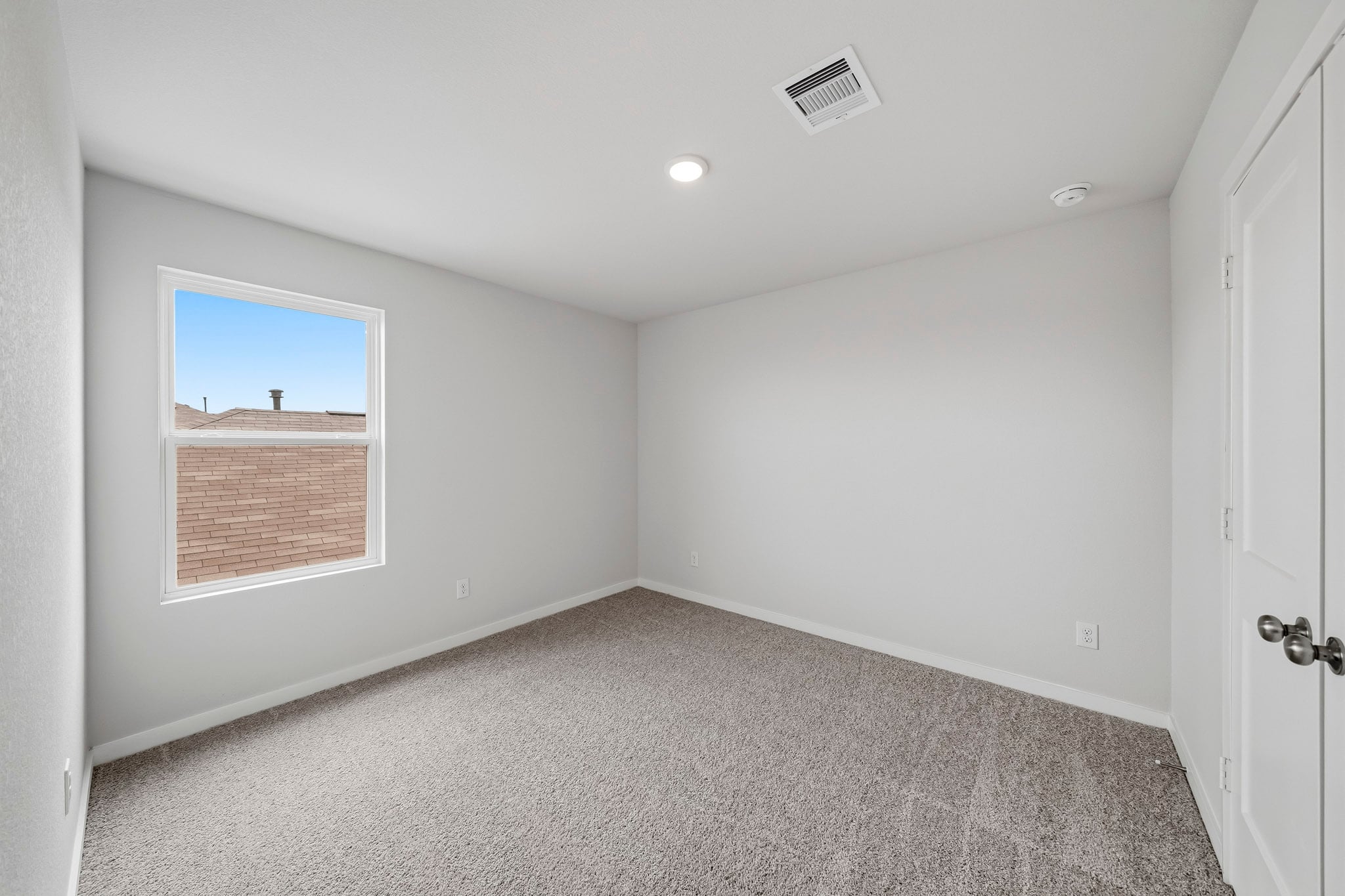 A room with a window and a door.
