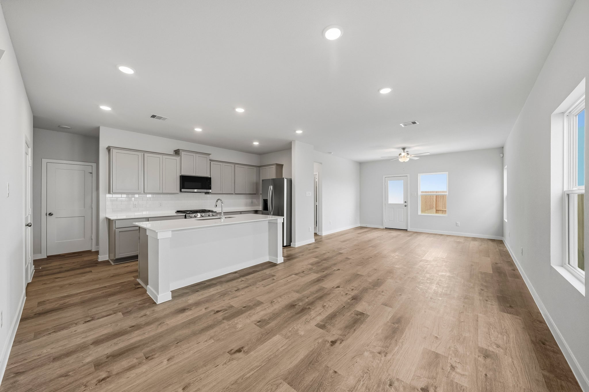 A kitchen with white cabinets.
