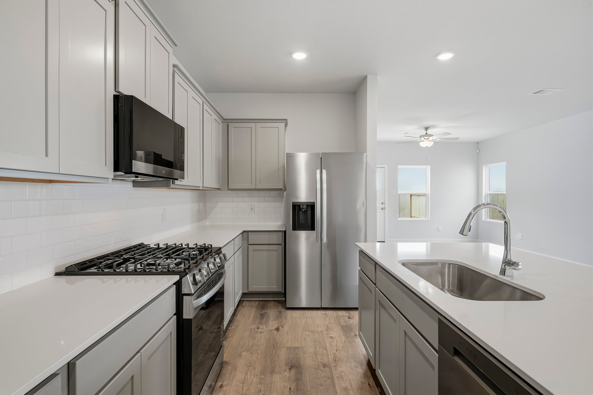 A kitchen with white cabinets.
