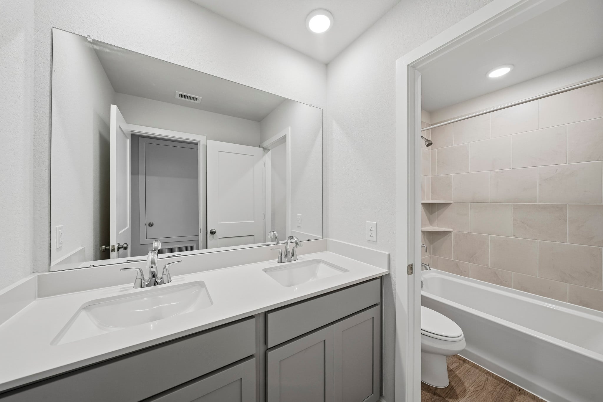 A bathroom with a tub sink and toilet.