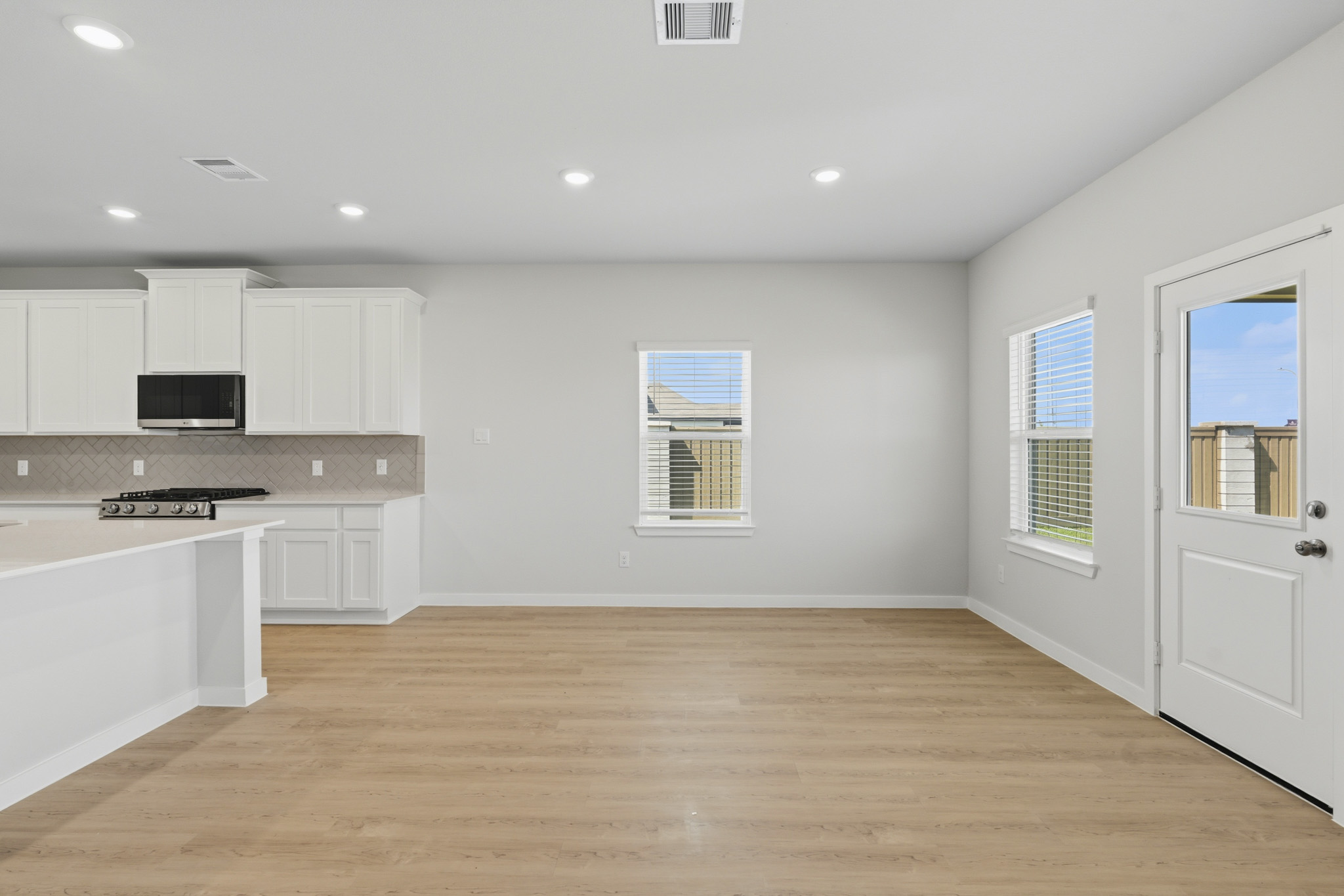 A kitchen with white cabinets.